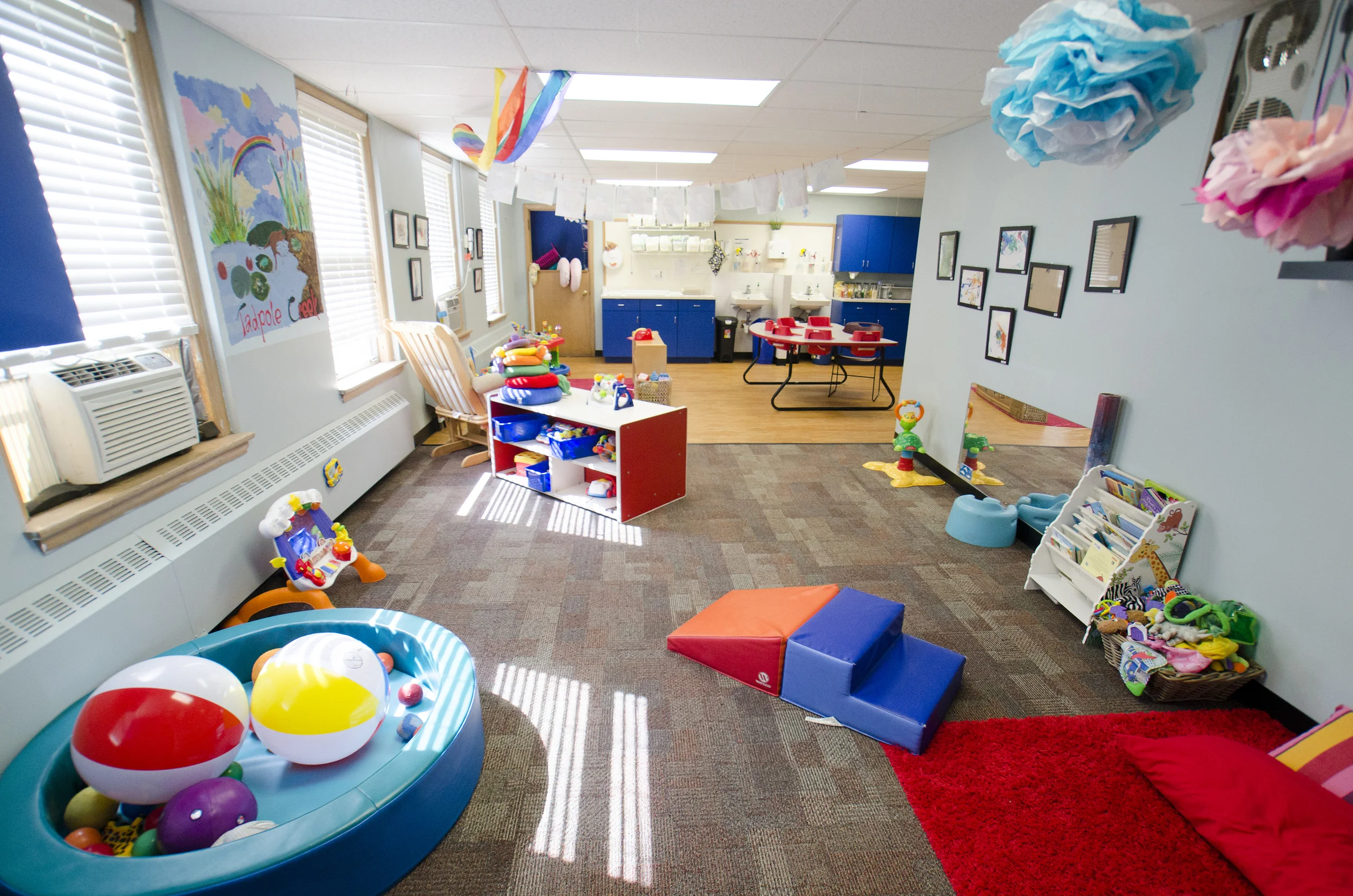 The infant room includes distinct areas for eating, exploring and sleeping.