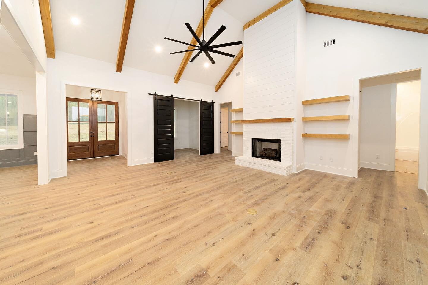 This living room is ready for Thanksgiving family time! The view showcases custom design features including cedar beams, shiplap, barn doors, and floating shelves. #kellywatsondesigner #ryanwatsonbuilder #customlandmarkproperties
.
.
.
.
.
.
.
#landm