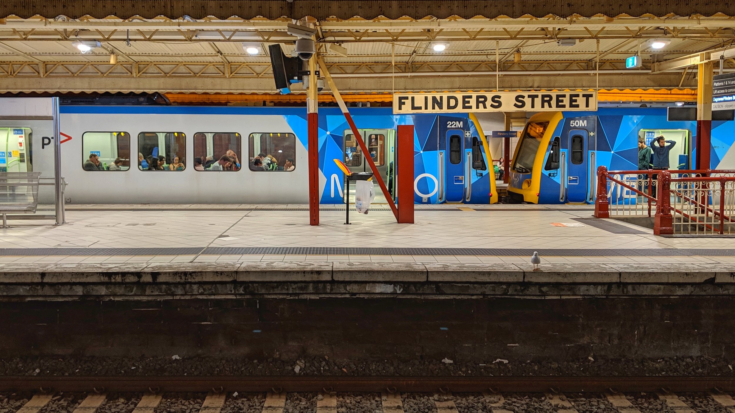 Waiting on a mostly empty platform at Flinders Street station.