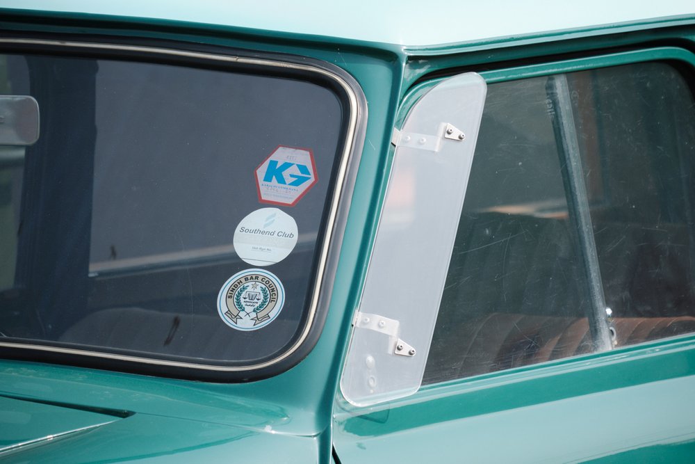 Three stickers on a windshield at Antique Car Show Karachi 2024