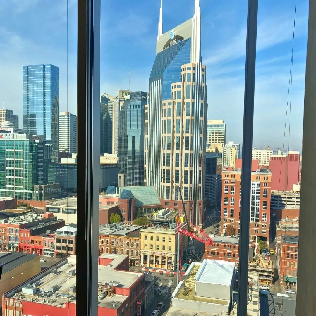 View of Nashville's iconic Batman Building and skyline through a window, representing professional counseling services in Nashville.