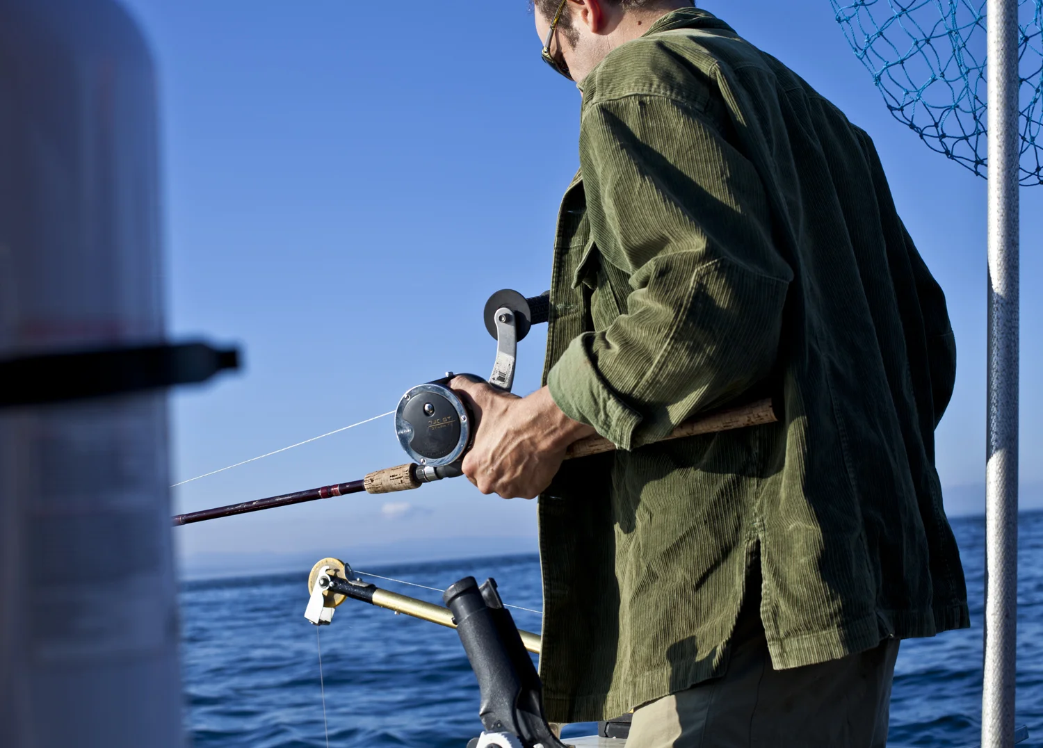 Steve preparing a rod while salmon fishing in the Strait of Juan de Fuca.