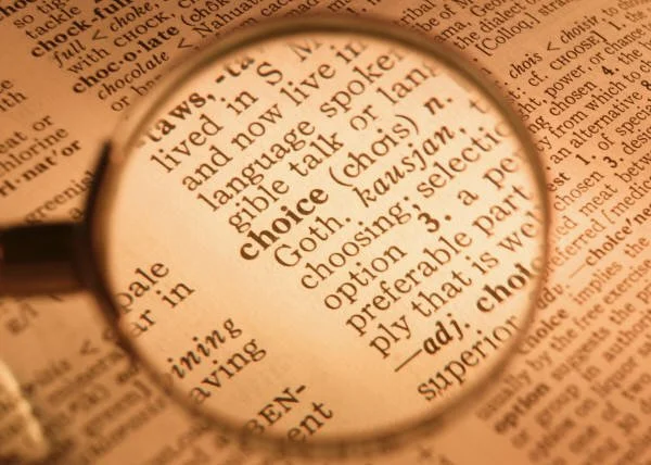 A magnifying glass over the word "choice" in the dictionary