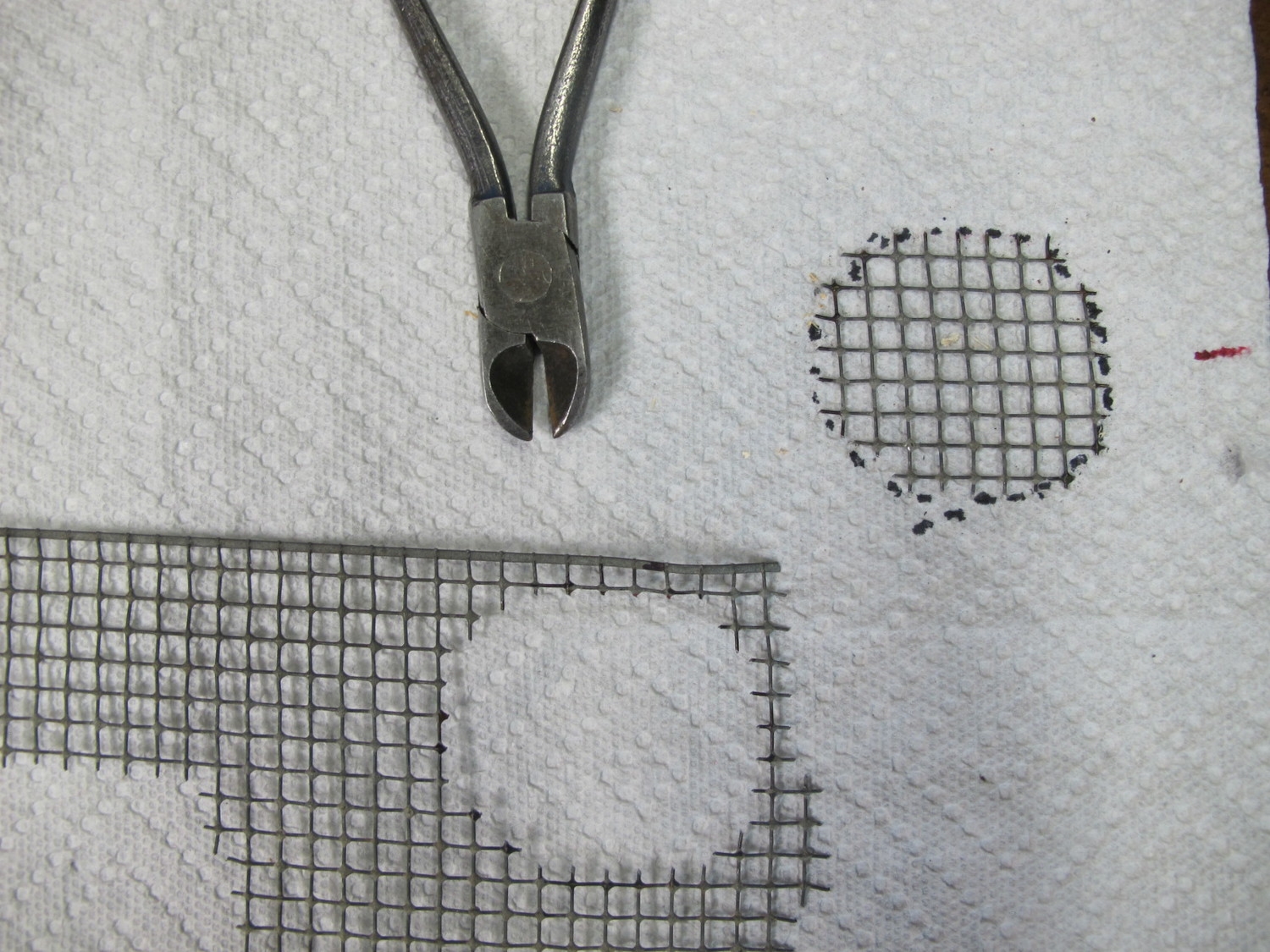  Wire mesh circular bottom cut out of wire mesh stock. 