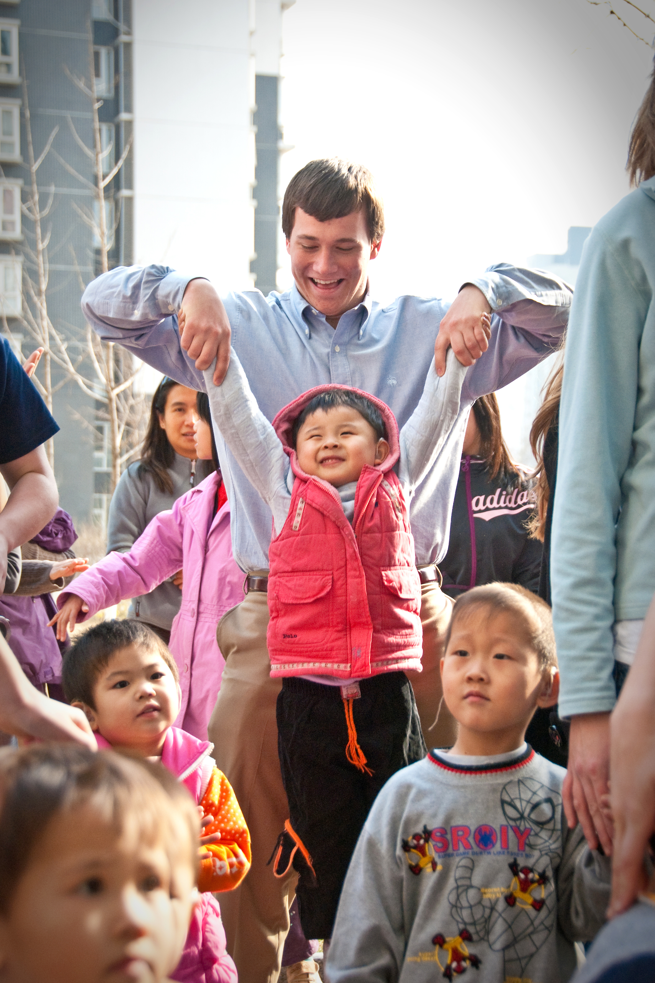  BEIJING, CHINA – Cameron Raidy, 18, of Pasadena, California plays with a young Chinese student with a cochlear implant at a school for the deaf in March 2009. 