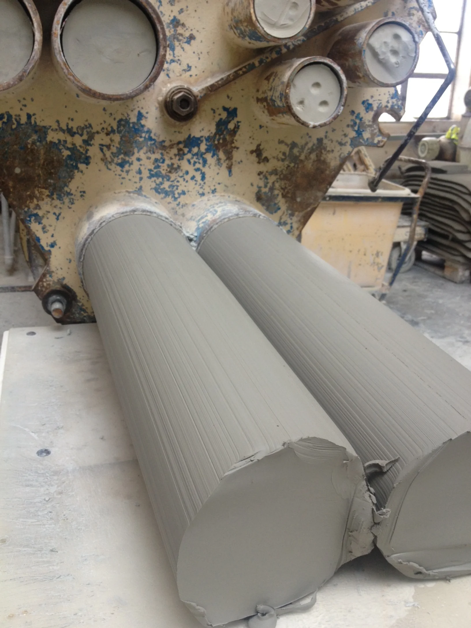 And then pushed through a pug mill to take any air out of the clay, the rolls of clay are ready for slices to be taken off for pressing plates, cups and bowls.