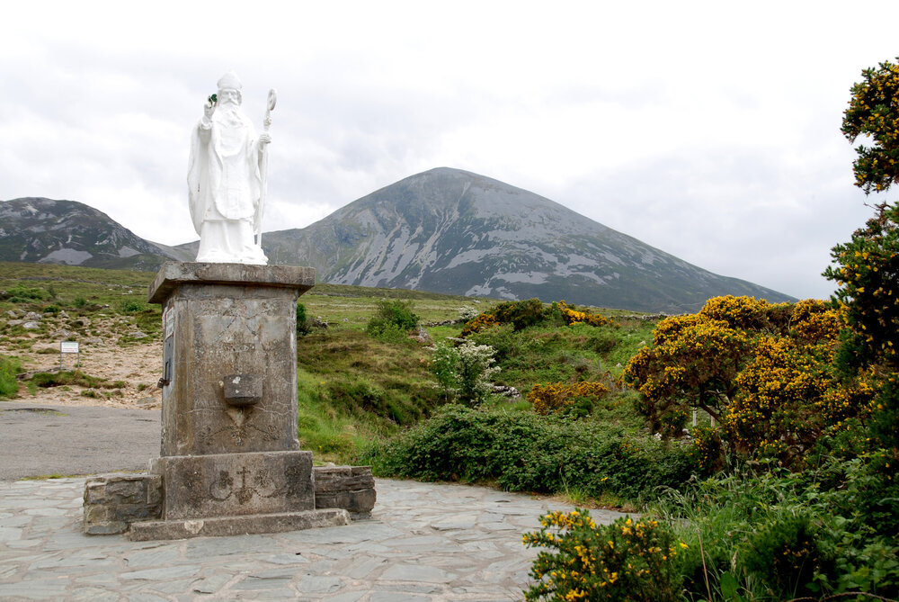 The mountain of Croagh Patrick and its namesake, the saint. Incidentally, there is gold in the mountain, potentially over €360 million in worth according to Wikipedia, but the county council decided not to allow mining.