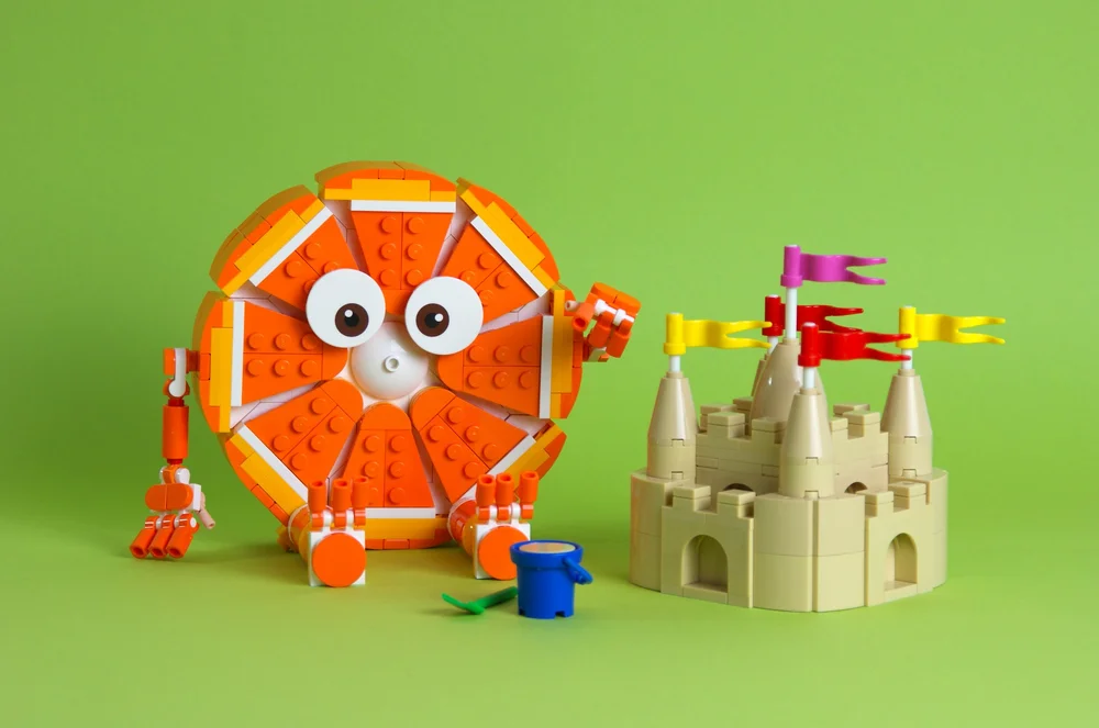 Orange Building a Sand Castle