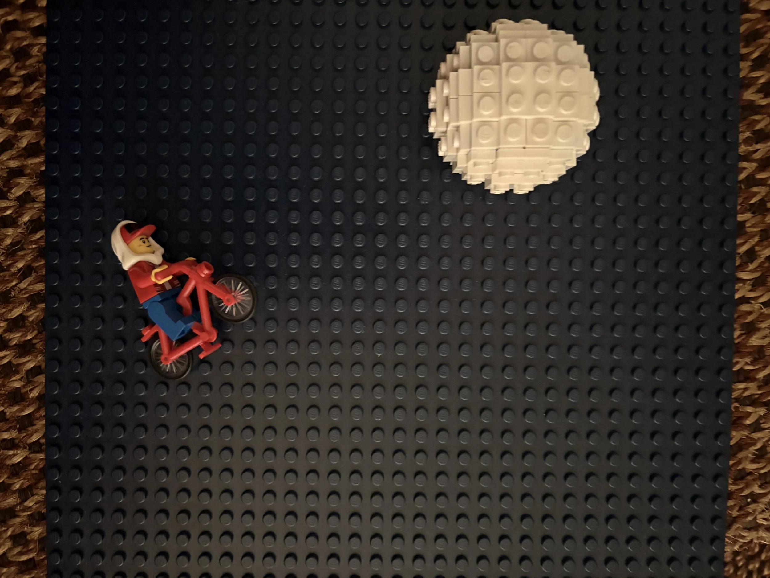 Elliott riding his bike in the night sky