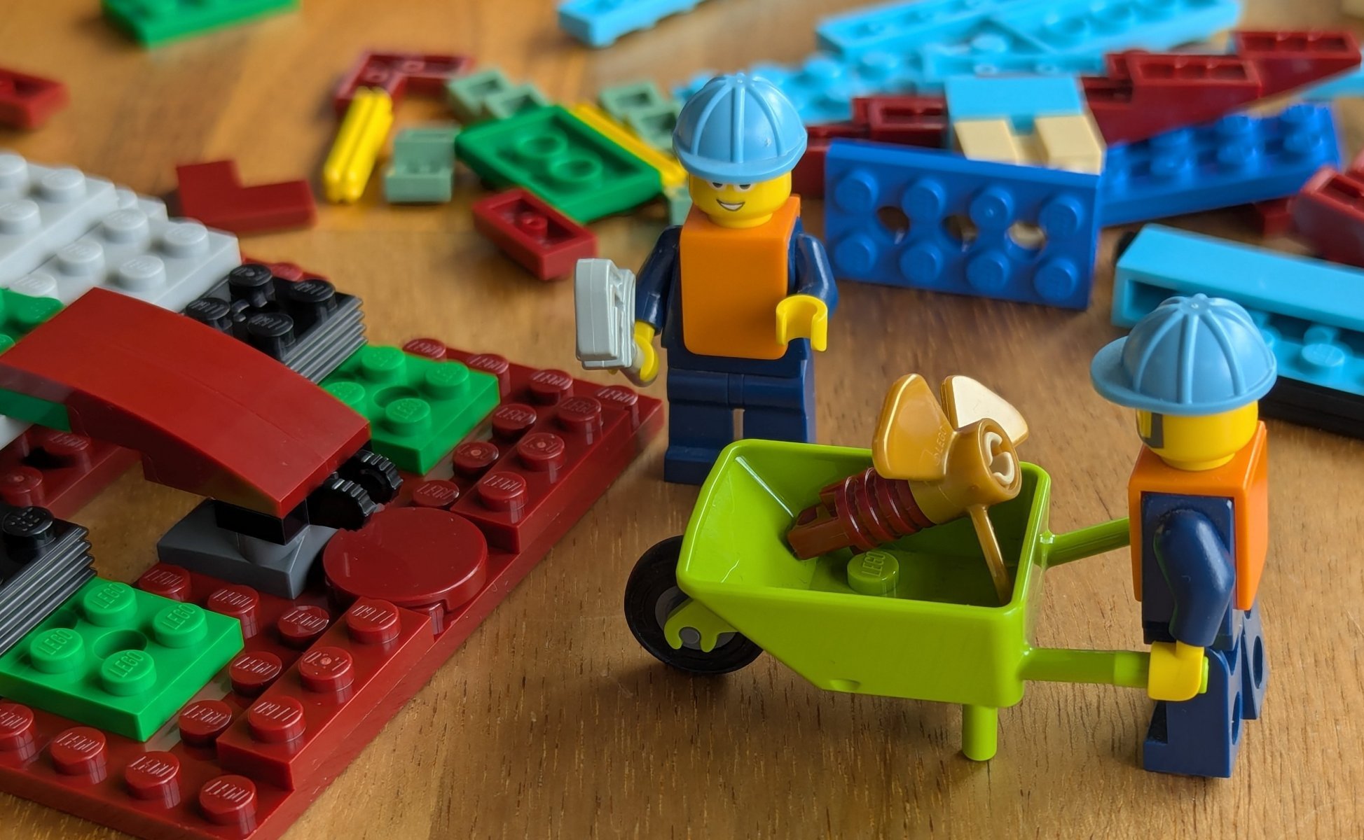 Minifigure delivering the propellor in a wheelbarrow.