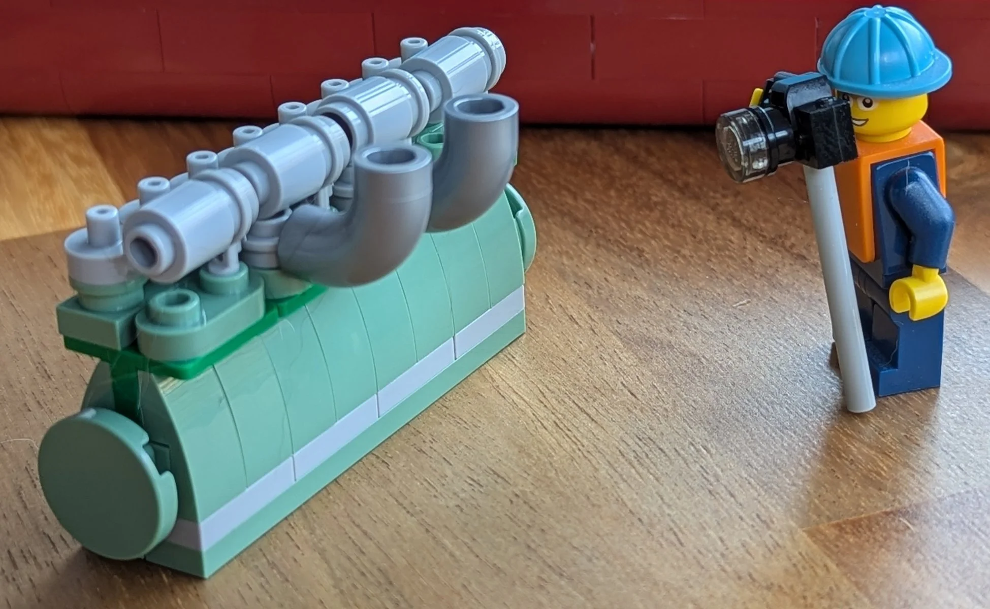 Minifigure taking a photo of the engine.