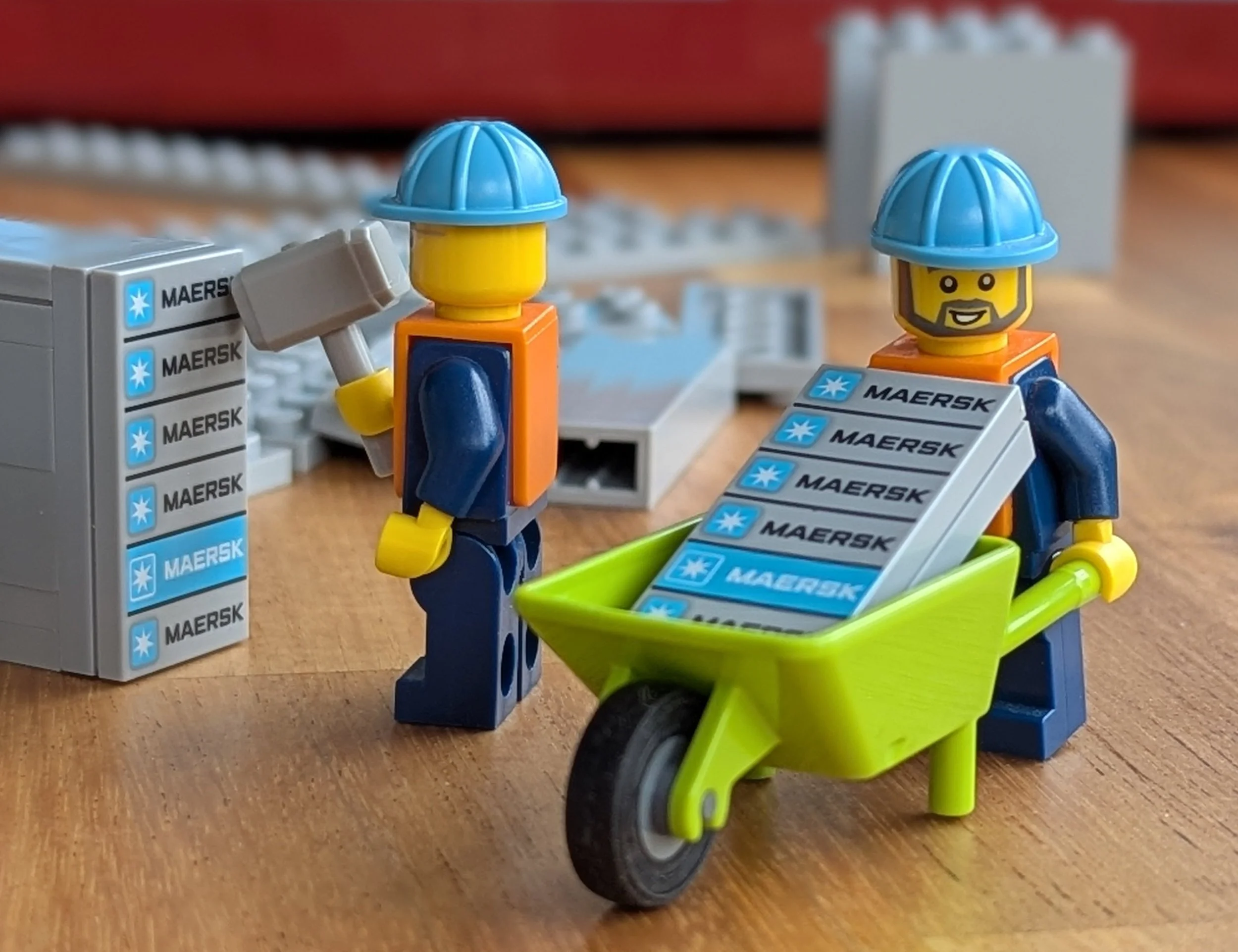 Two minifig construction workers building tiny containers