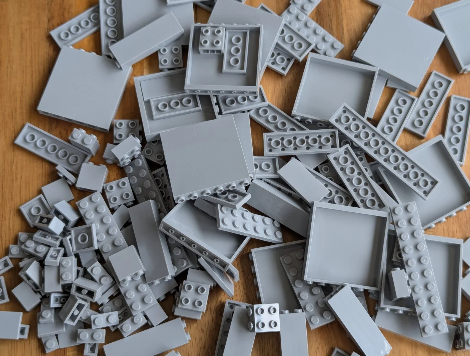 A pile of grey bricks and plates.