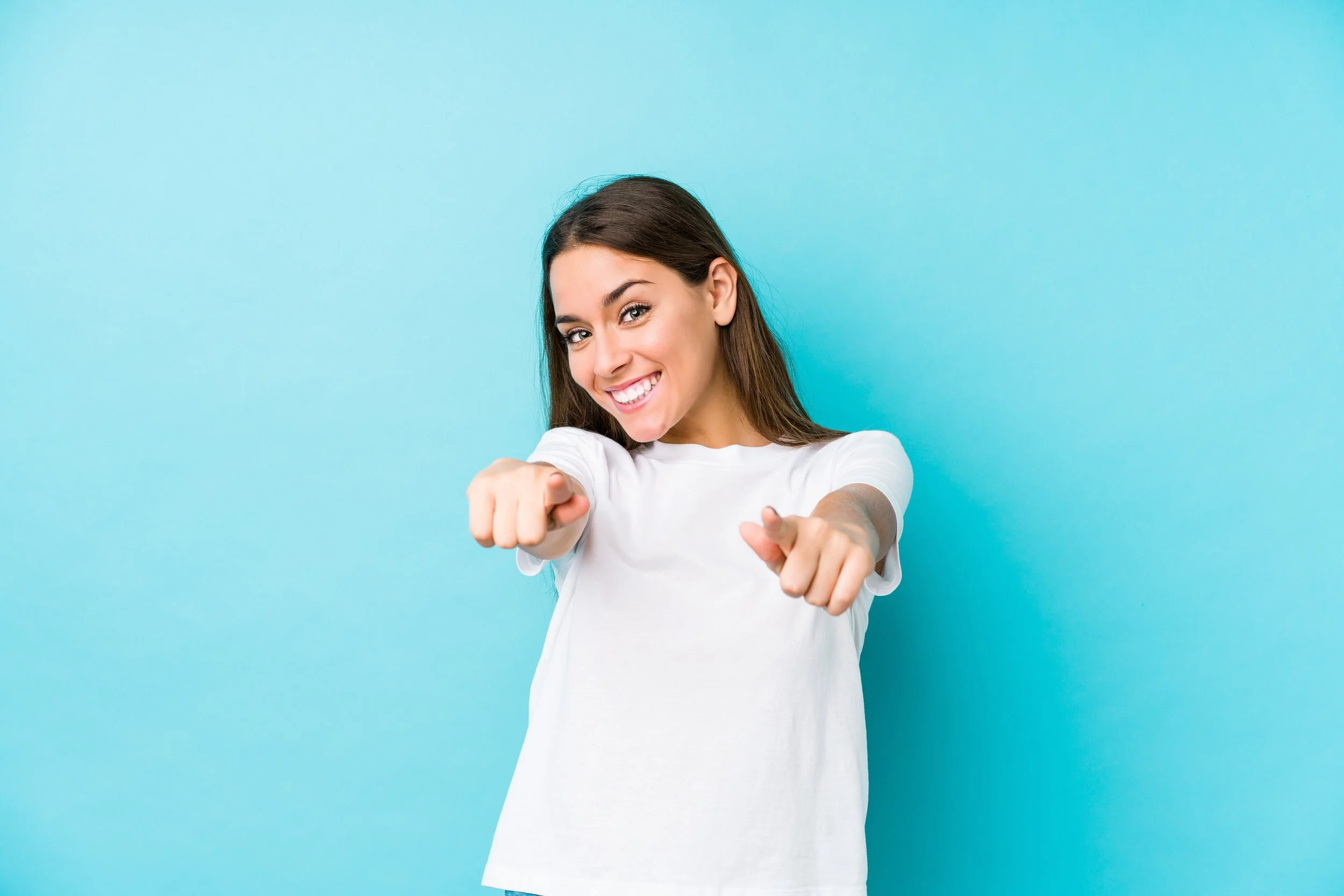 Girl Pointing with Turquoise Background - AdobeStock_315987583.jpeg