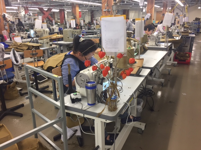 I love the splash of floral color amidst the otherwise industrial sewing stations.