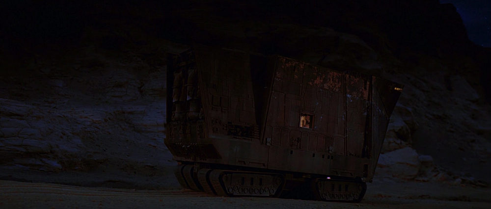 EXT. TATOOINE - ROCK CANYON - SANDCRAWLER - SUNSET