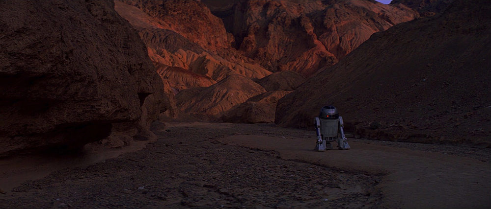 EXT. TATOOINE - ROCK CANYON - SUNSET