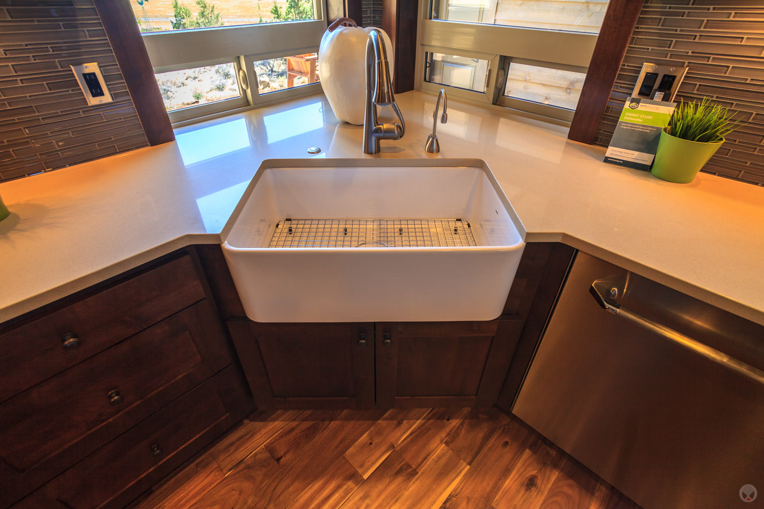A porcelain farm sink. Also note: Shaker-style cabinets, stainless steel appliances, and subway tile backsplash.