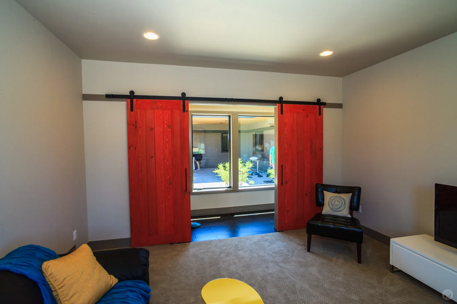 Barn-style doors hung on an exposed track.