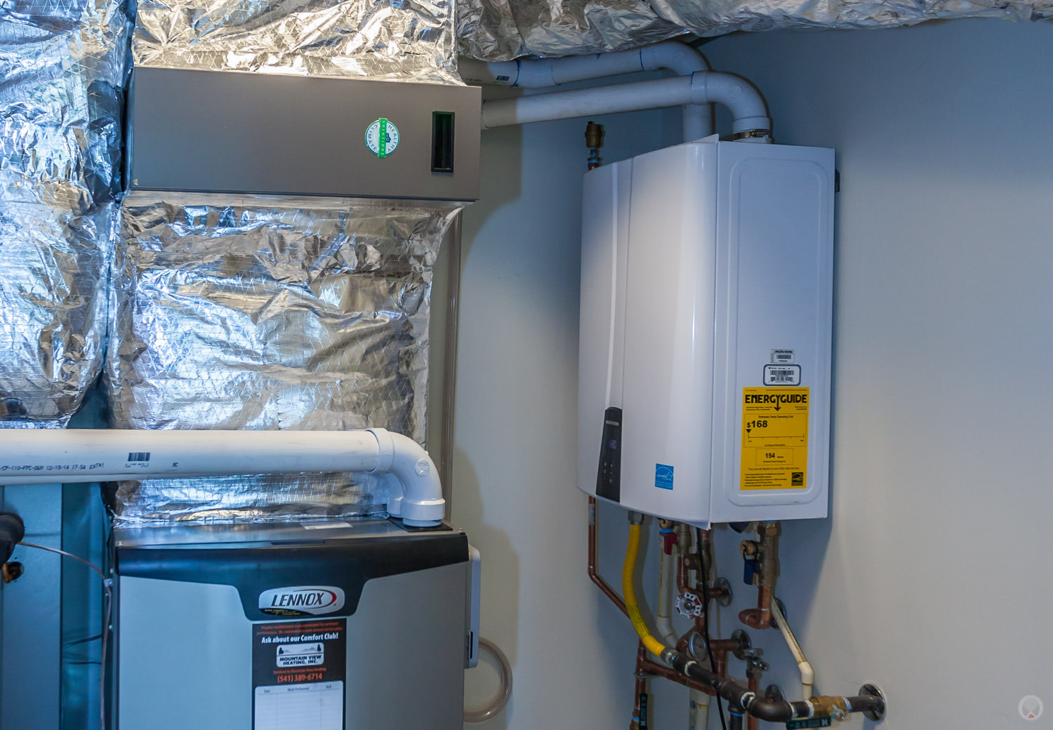 A tankless water heater (the white box with the yellow energyguide sticker) takes up less room and is more efficient than a regular water heater.