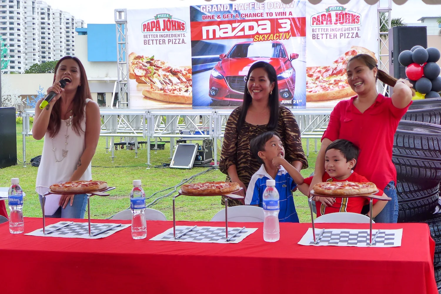 Pizza-eating contest participated by moms and their kiddos