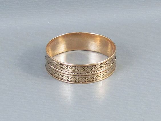 Antique Victorian 9k gold engraved tapestry pattern cigar band. Source.