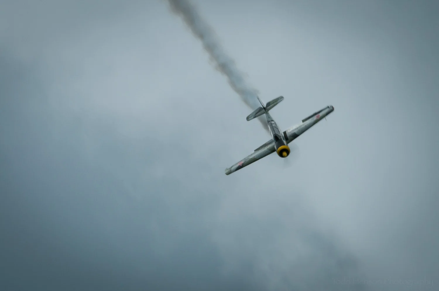 Yak-52 Descent. Pilot: Charlie "V+12" VandenBossche. Camera settings: 360mm, 1/60 sec, f/45
