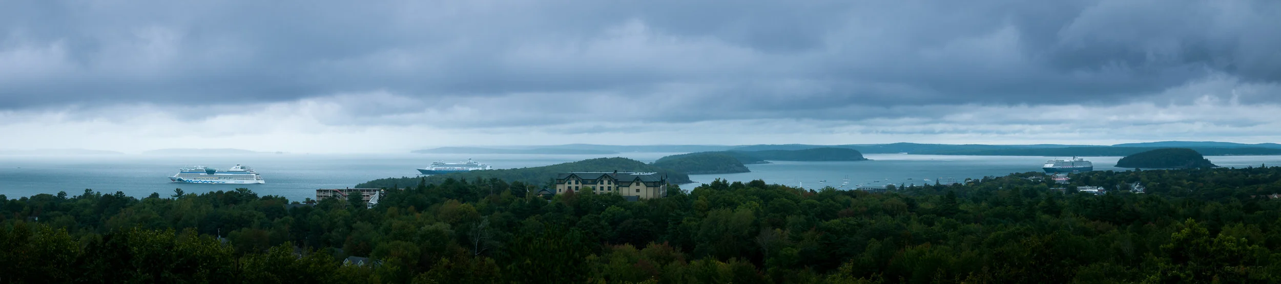 Final stitched panorama showing 3 cruise ships docked at Bar Harbor, Maine, in stormy weather.