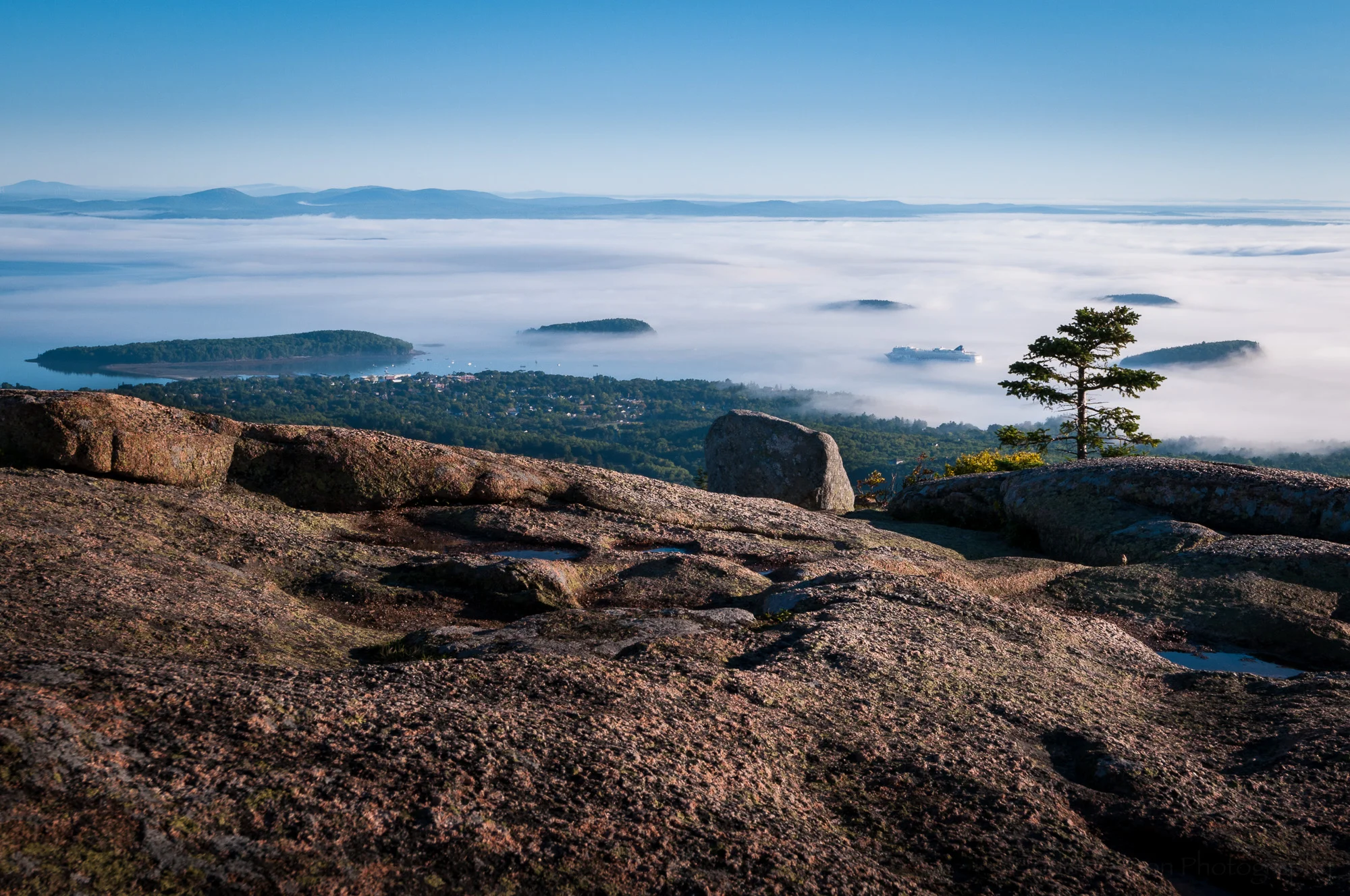 Granite top of Cadillac Mountain with view of Bar Harbor and cruise ship