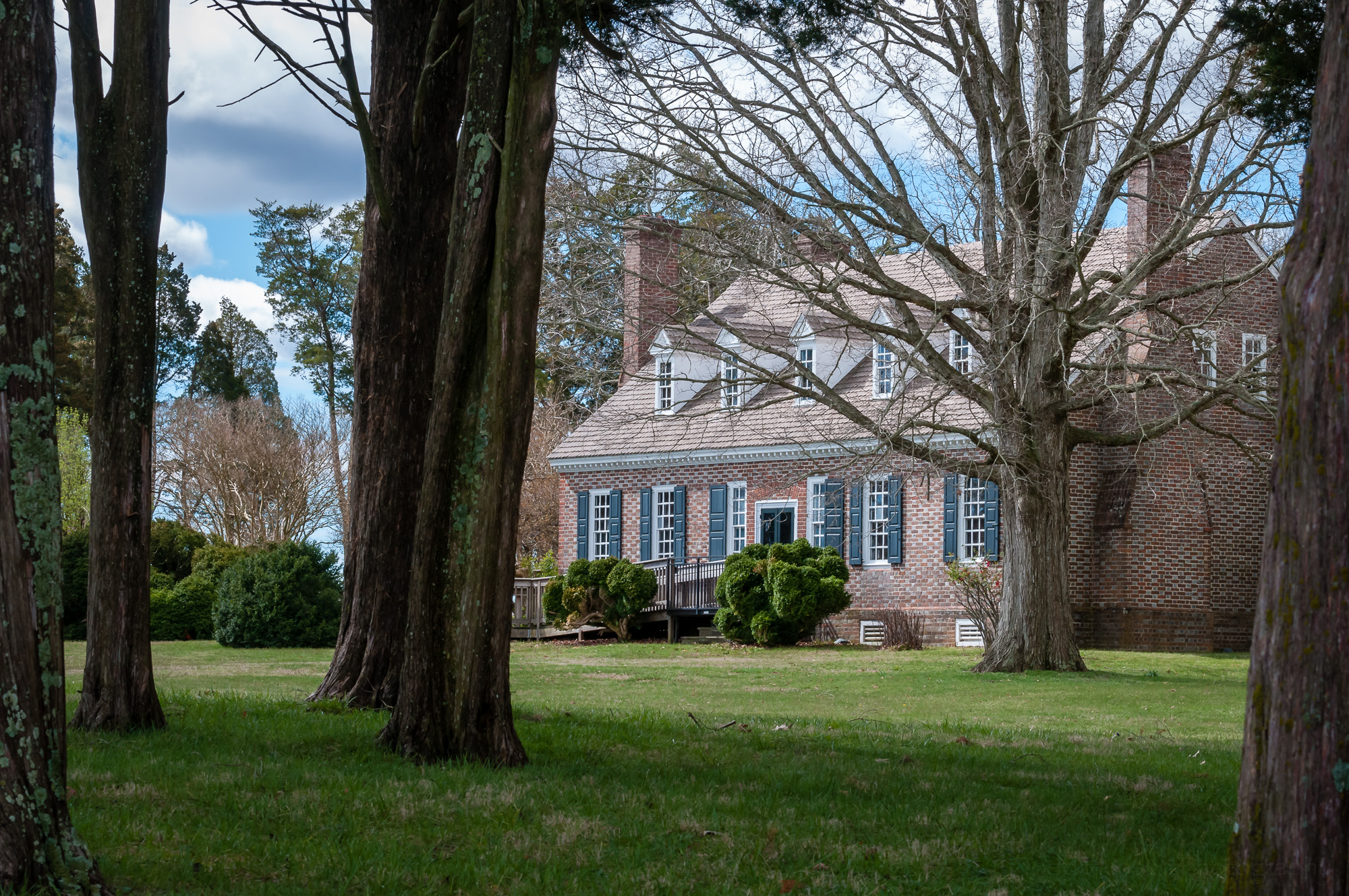 View of the Memorial House through the trees.