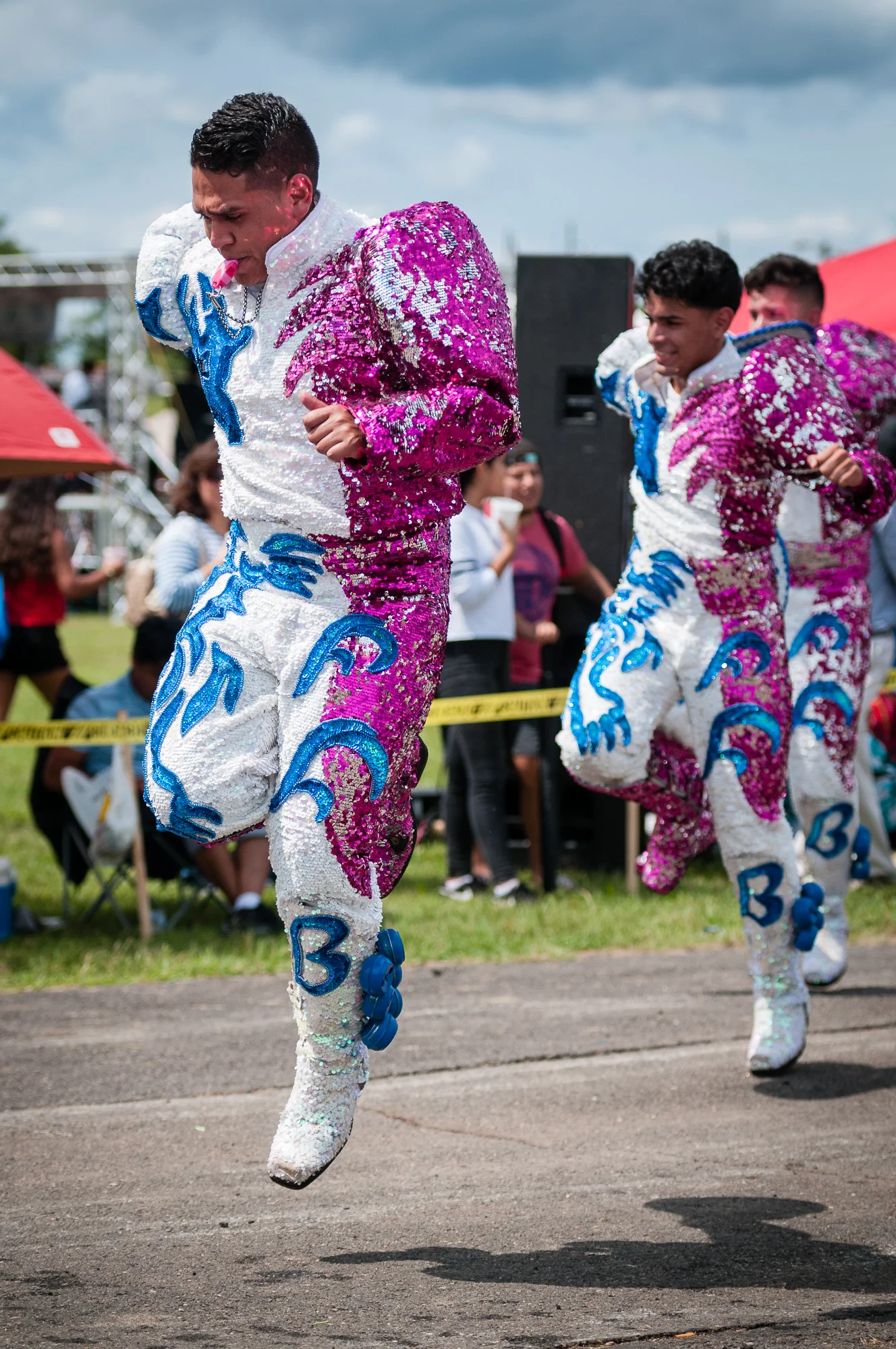 The Caporales dance performed by Fraternidad Folklorica Bolivia included energetic jumps and costumes that reflected colored light into their faces when the sun shone on them. Direct sunlight is not always a bad thing.