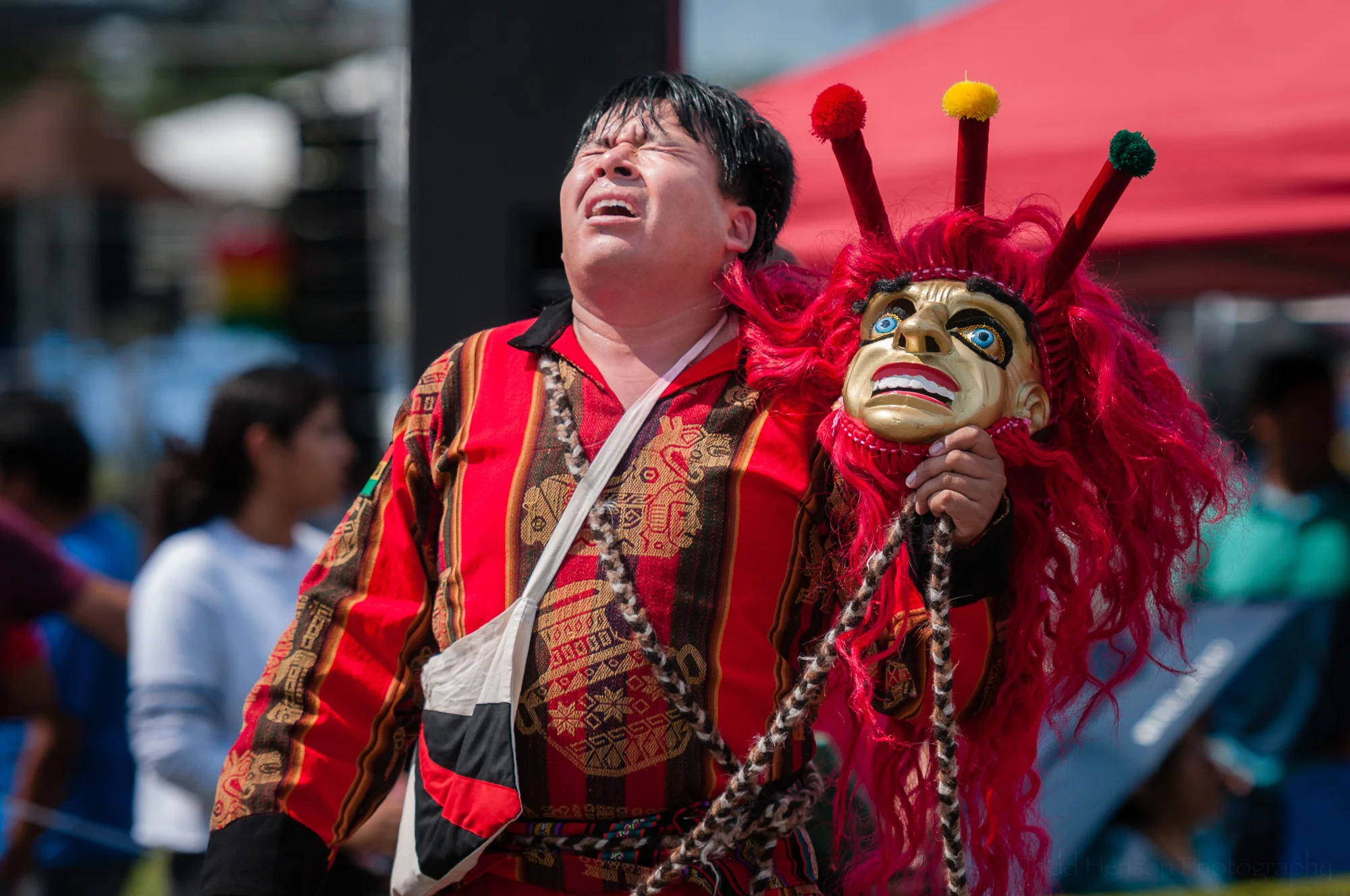 In this photo I captured the moment after the performer from Fundacion Socio Cultural Diablada Boliviana removed his mask after their final performance of a Wititi dance. You can see his exhaustion as he lifts his head towards the sun.