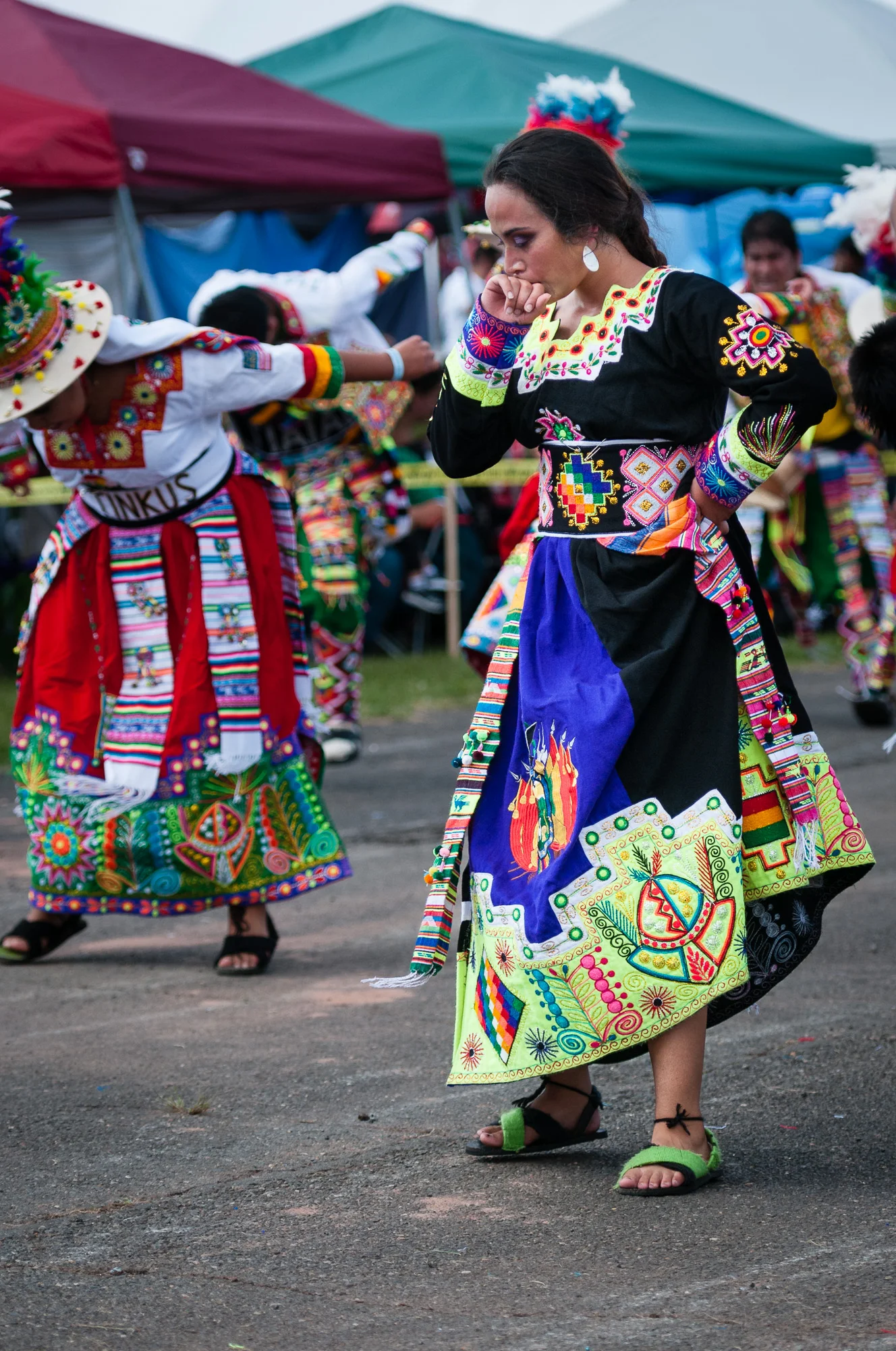 Here a performer from Tinkus Tiataco pauses during the Tinkus dance, raising her hand to her mouth. What was she thinking? What was she feeling? 