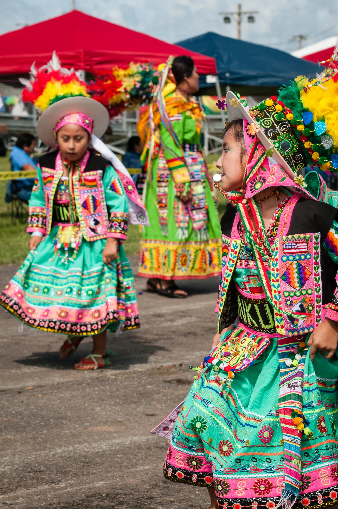 This photo captures a moment from a Tinkus dance performed by Tinkus Bolivia. I believe the girl with the whistle is leading her group within the dance. I like her pose and the positioning of the other people with the image.
