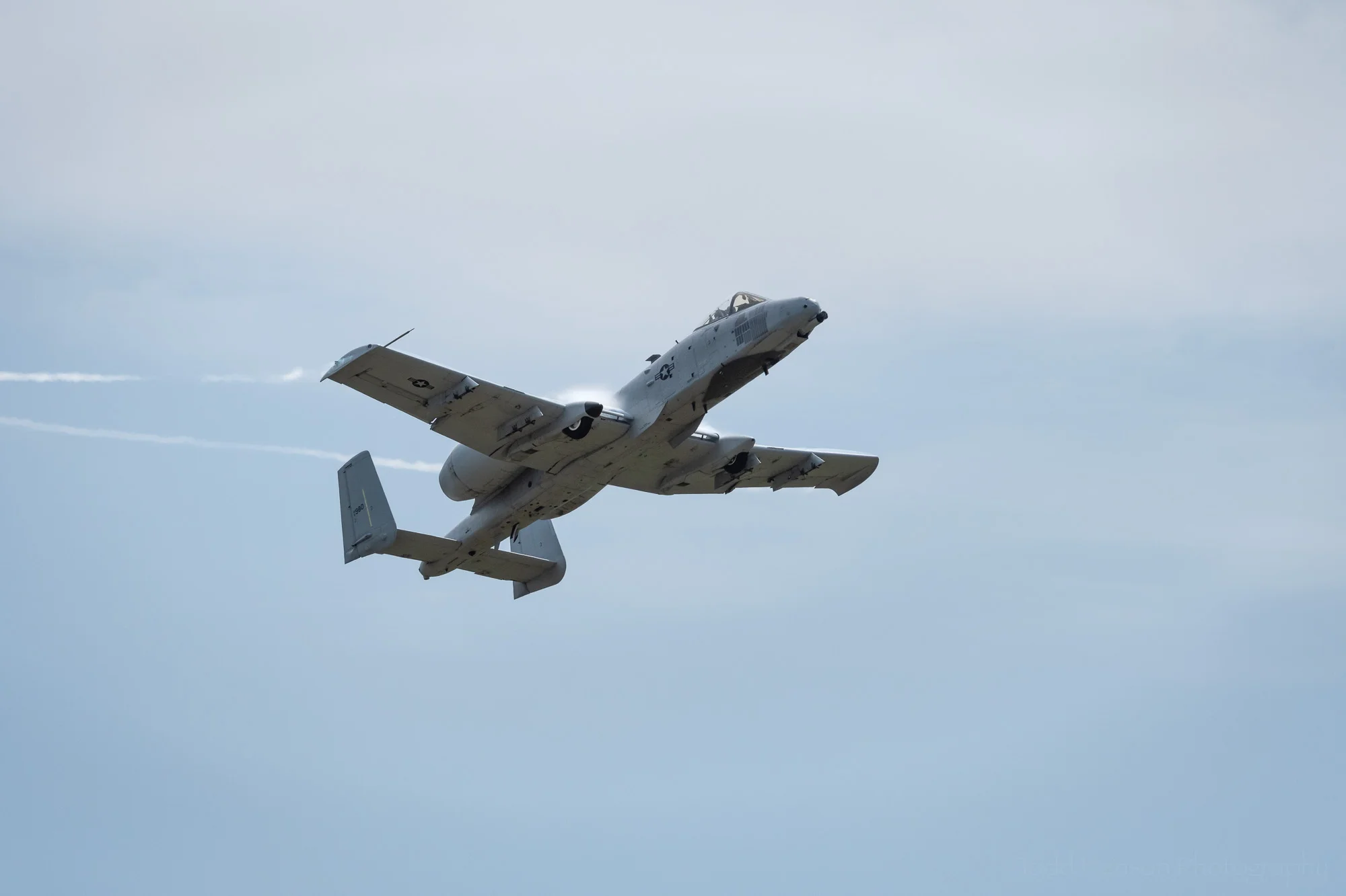 USAF A-10 Thunderbolt quickly changing orientation. Notice the air being forced over the tops of the wings near the fuselage and trailing from their tips.