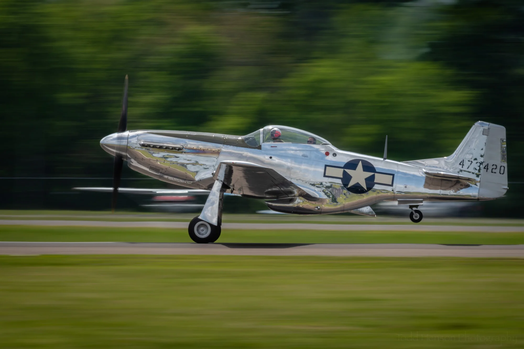 P-51 Mustang taking off. The rear tire has already left the runway.