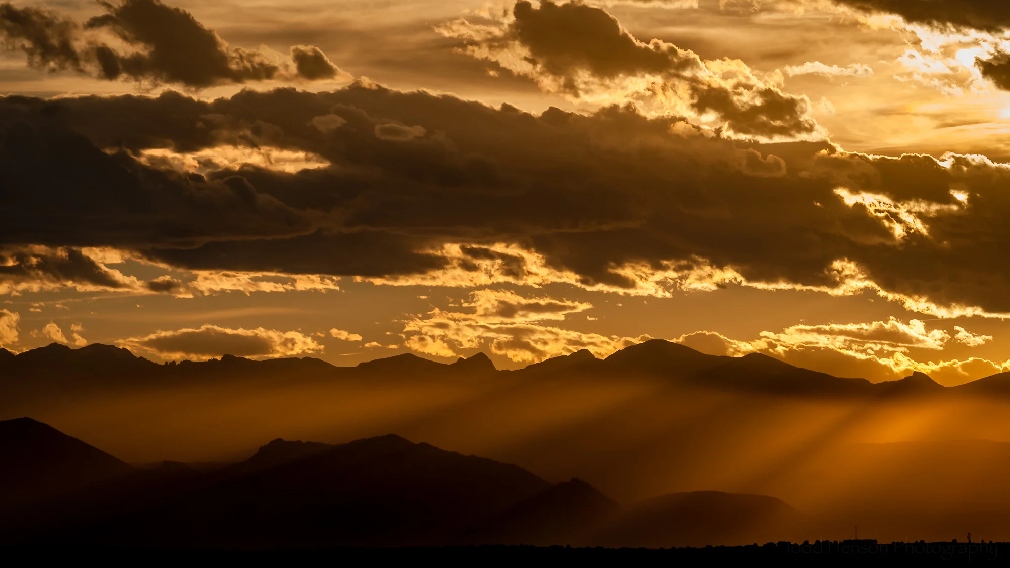 Dreaming of Denver. I dream of Denver, facing west, watching the setting sun set the sky afire, rays of soft filtered light rippling over the silhouetted peaks of the Rocky Mountains. It brings warmth even on the coldest of nights.