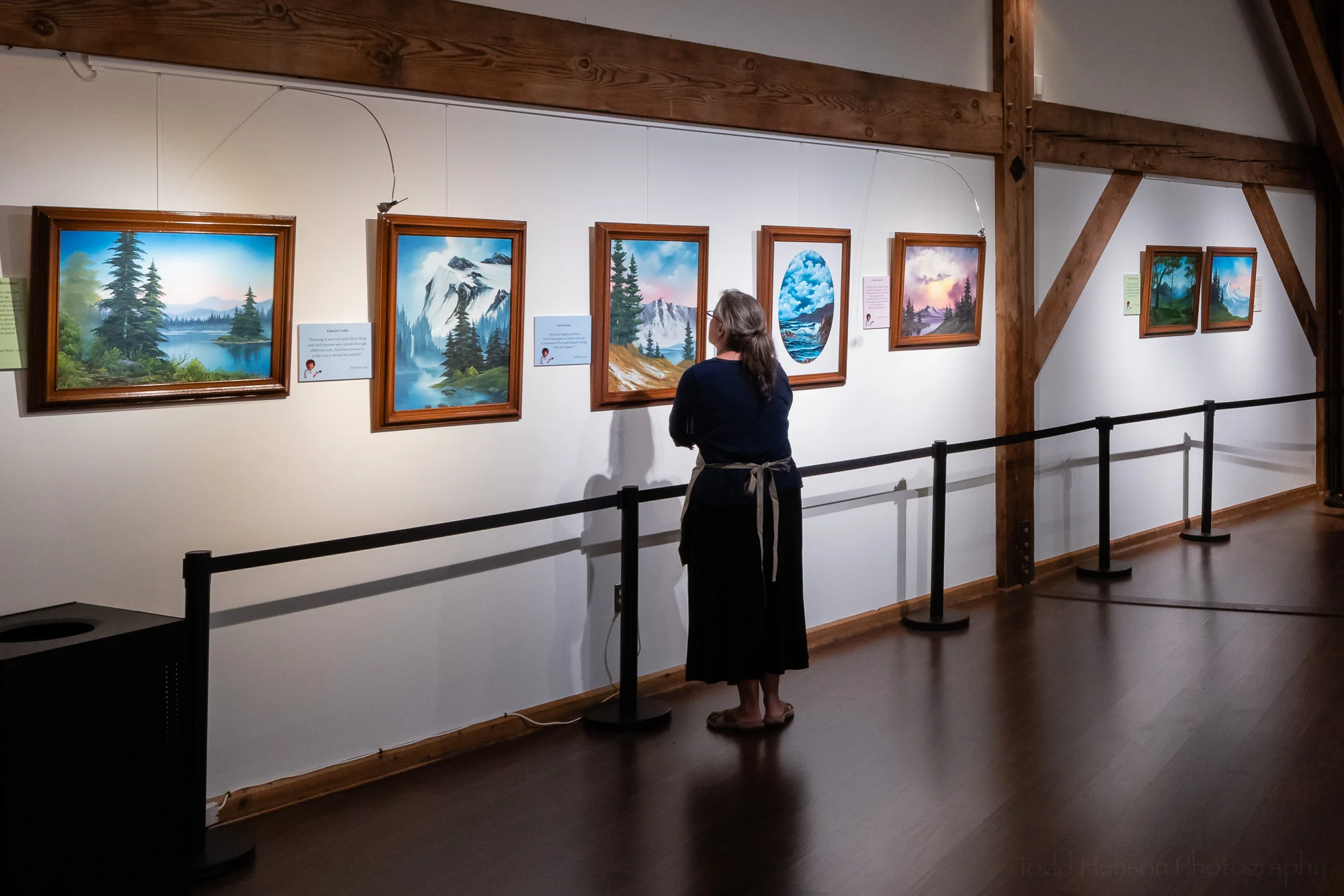 Viewing paintings by Bob Ross at the Happy Accidents exhibit
