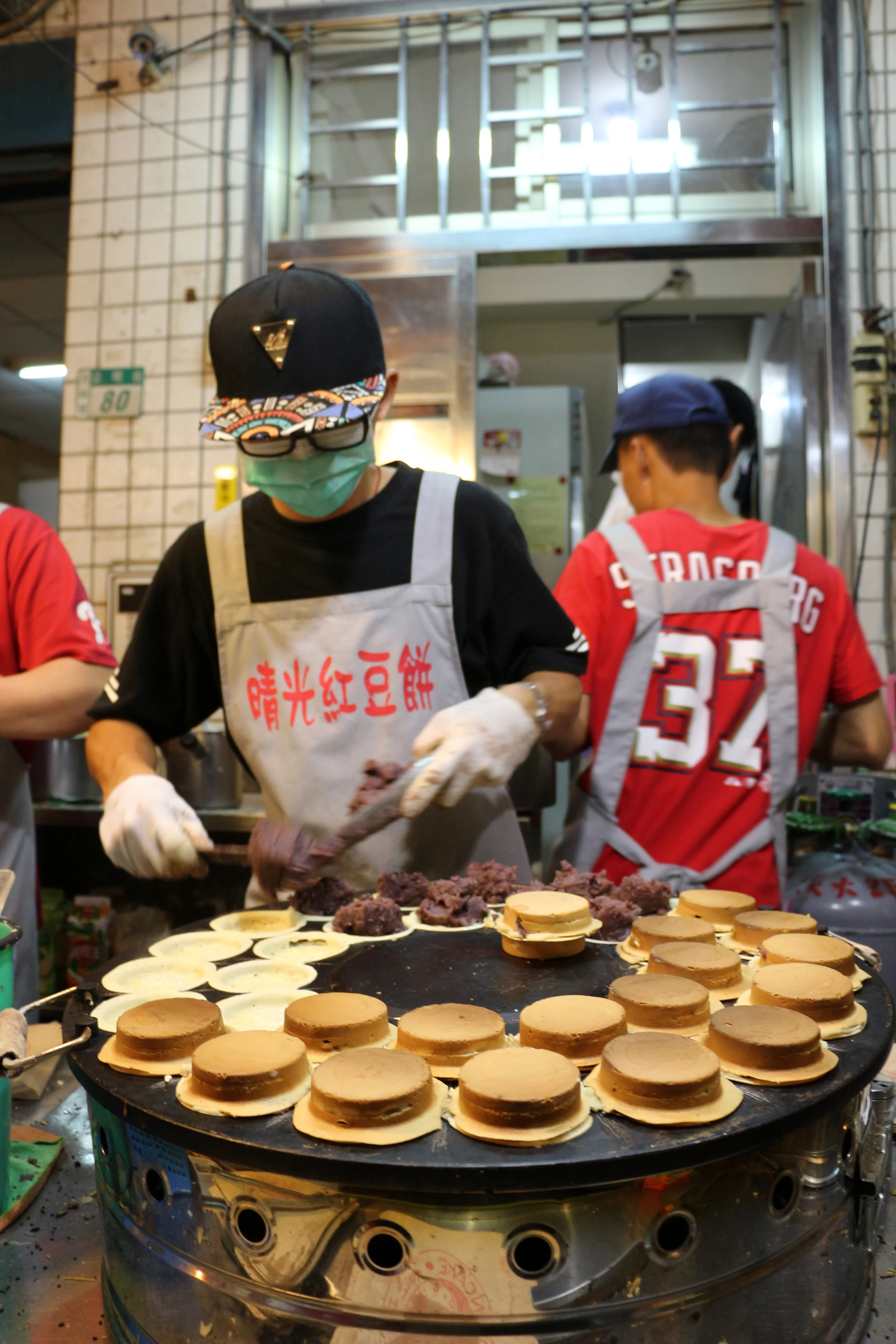 A street chef prepares baked sweet bean cakes. We had a couple of these and they are quite good. If we weren't so full from the other cake we probably would have eaten more. 