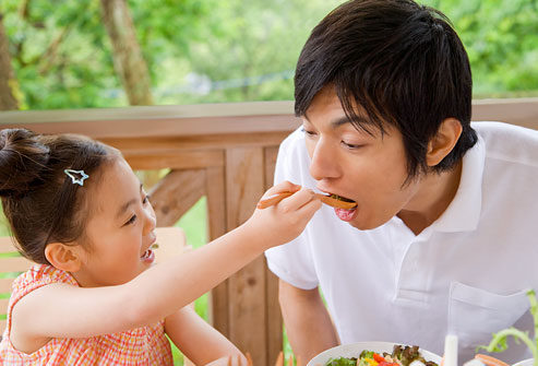getty_rf_photo_of_dad_leading_by_example_eating_veggies.jpg