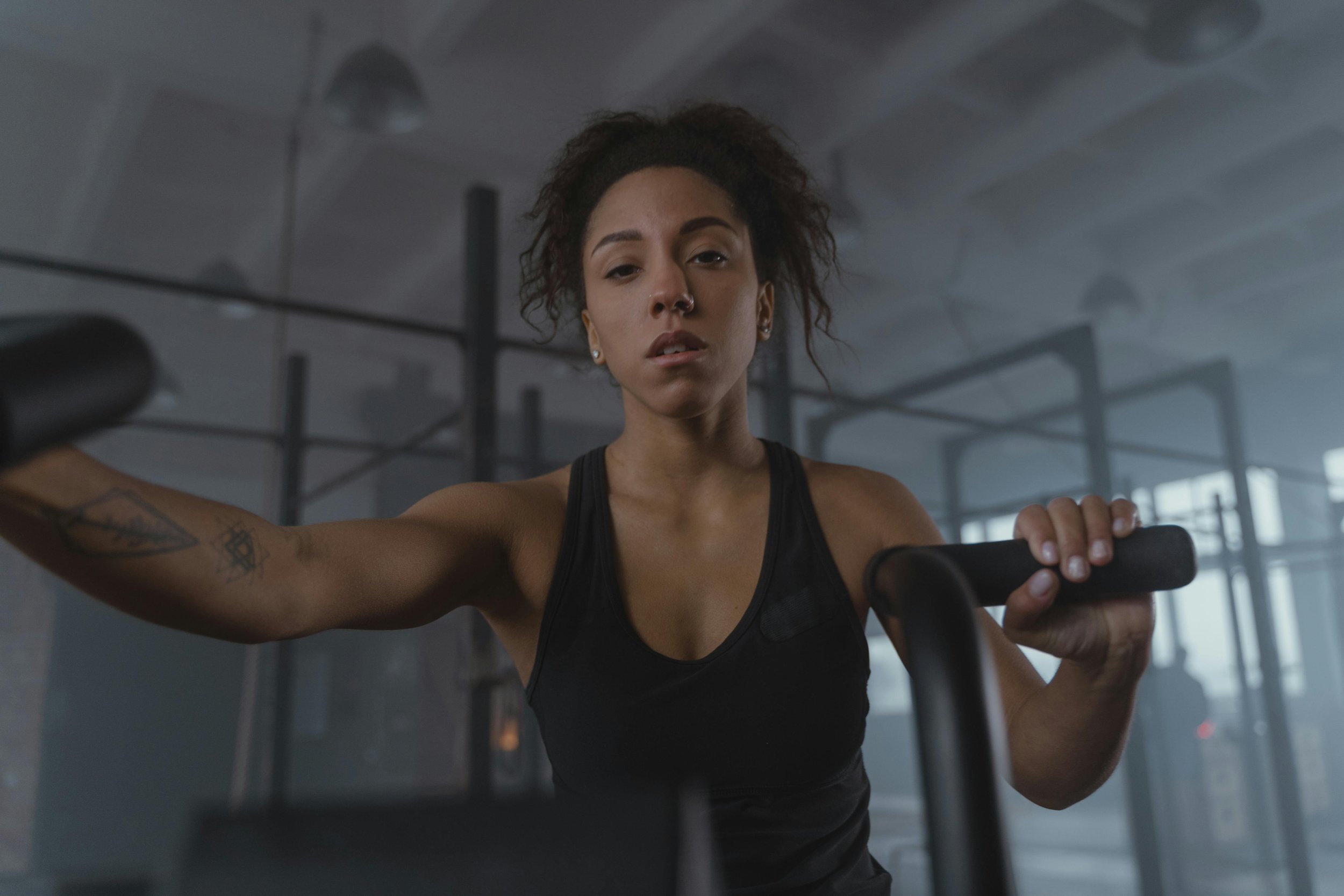 Close-Up Shot of a Woman in Black Tank Top Exercising