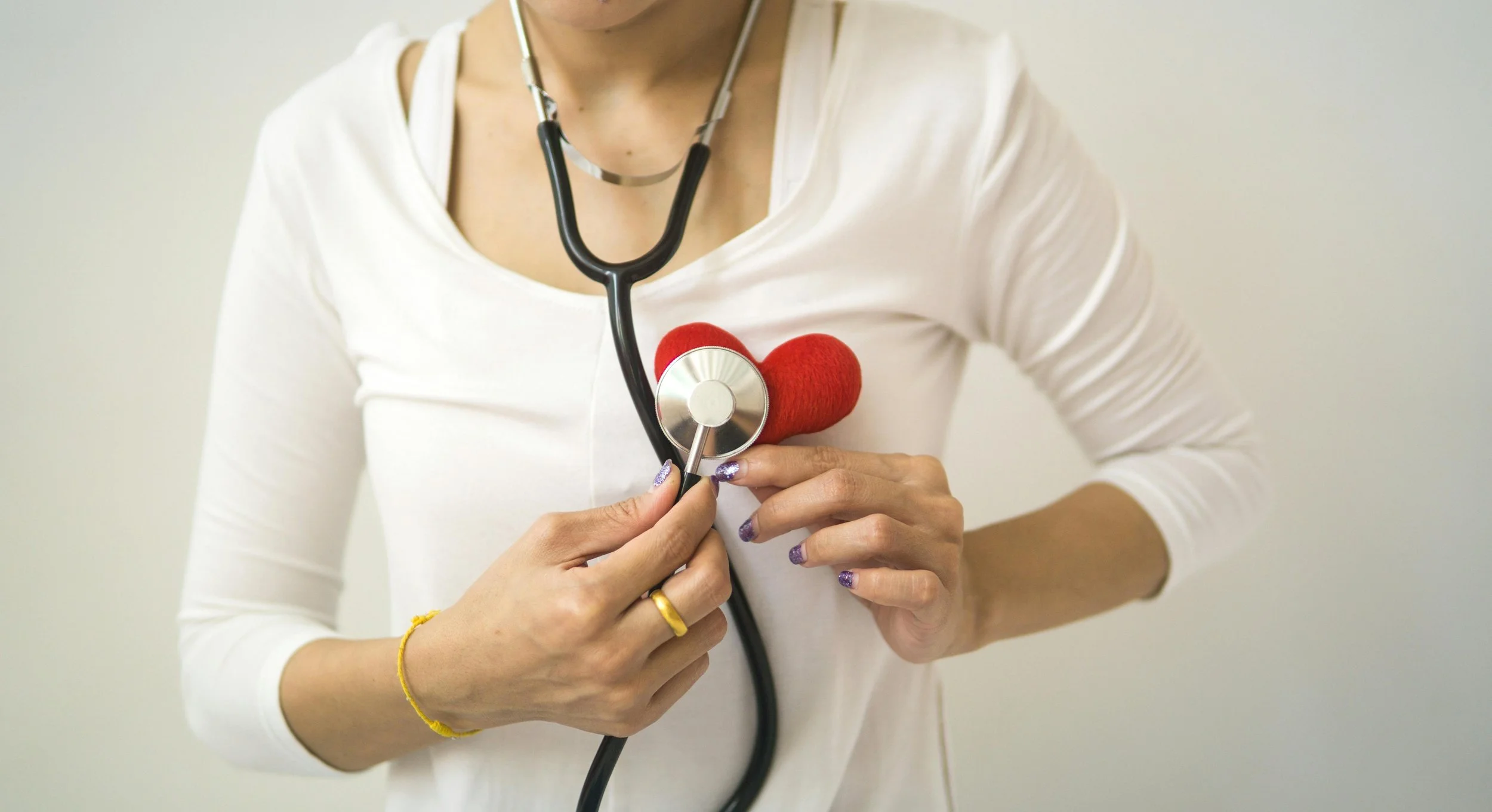 Crop woman with stethoscope on neck
