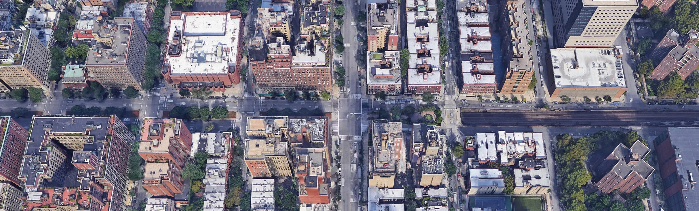 The visible transition of neighborhood character at 97th Street in the Upper East Side in Manhattan, where the Metro North rail lines emerge from below Park Avenue and continue into the Bronx. 