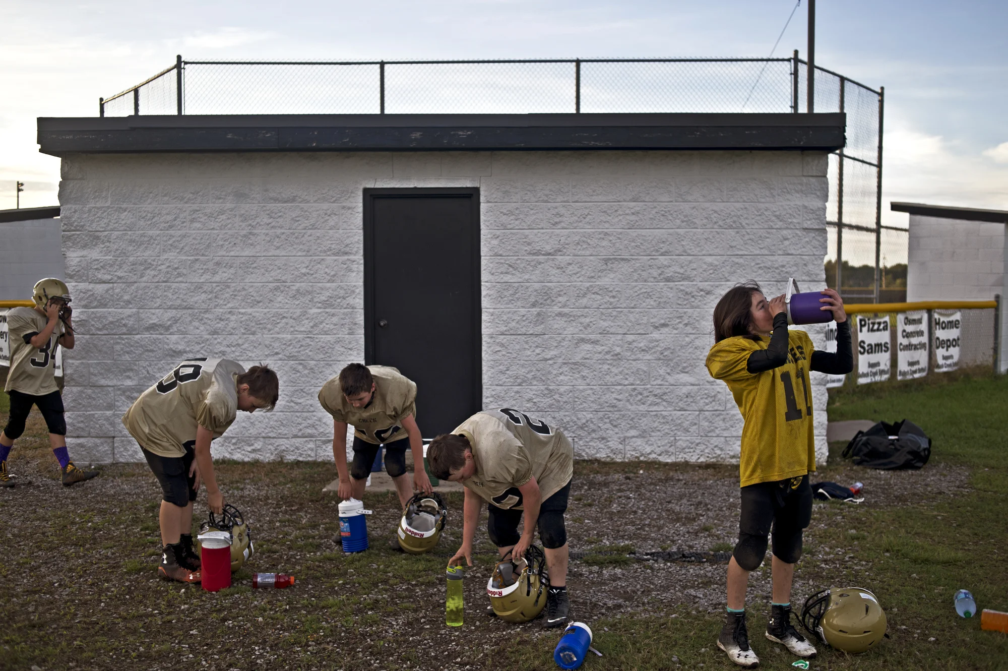  From left, members of the Bullock Creek Youth Football Program Sixth-Grade Team Drew Nestle, Parker Grzegorczyk, Dominik Gohl, Austin Chapin and Sophie take a water break halfway through practice on Sept. 29 in Midland, Mich. 