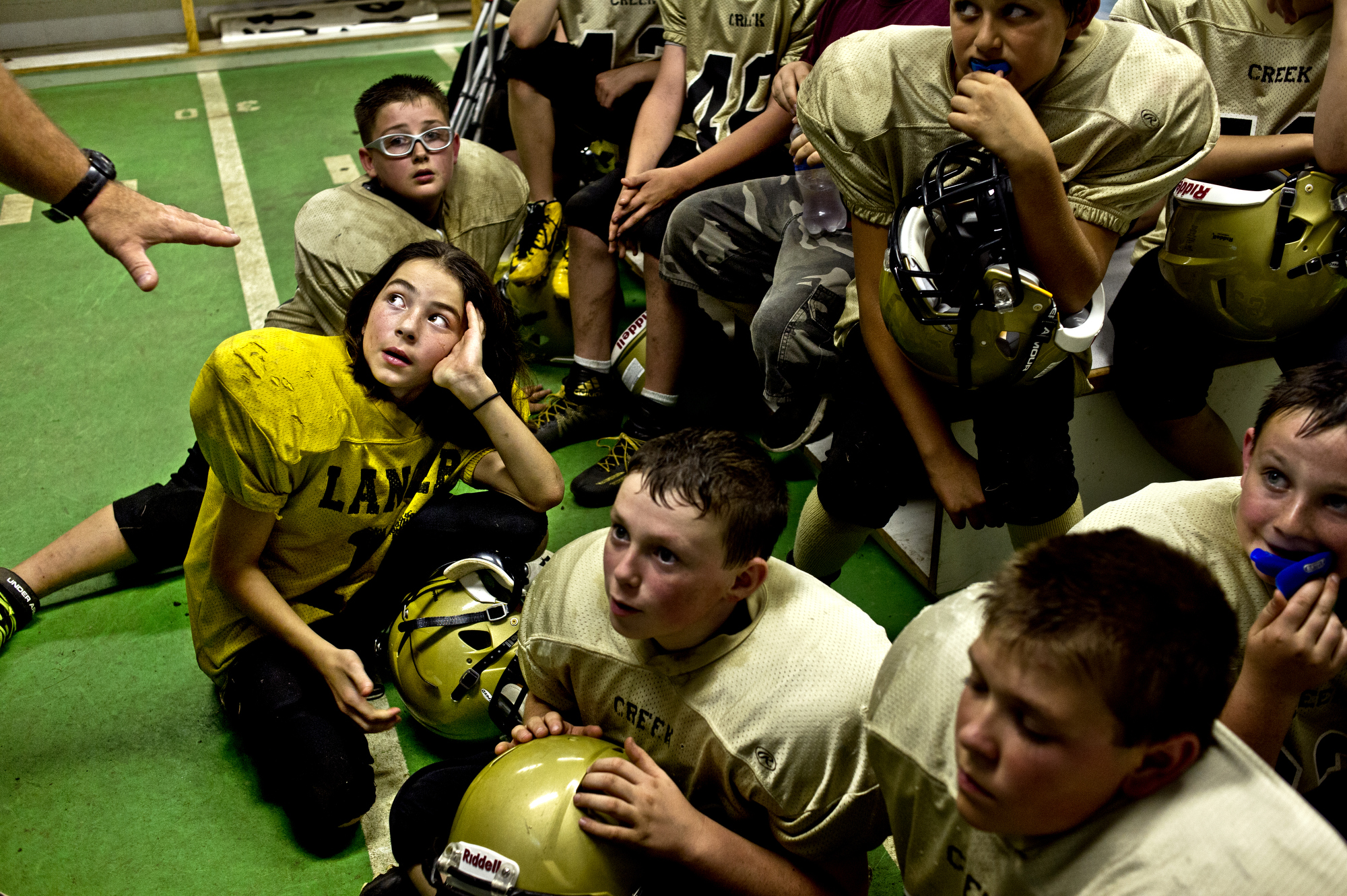  Head coach Pete Kirk motions to Sophie as she and her teammates review tape from their 14-0 victory over Chesaning at practice on Sept. 28 in Midland, Mich. 