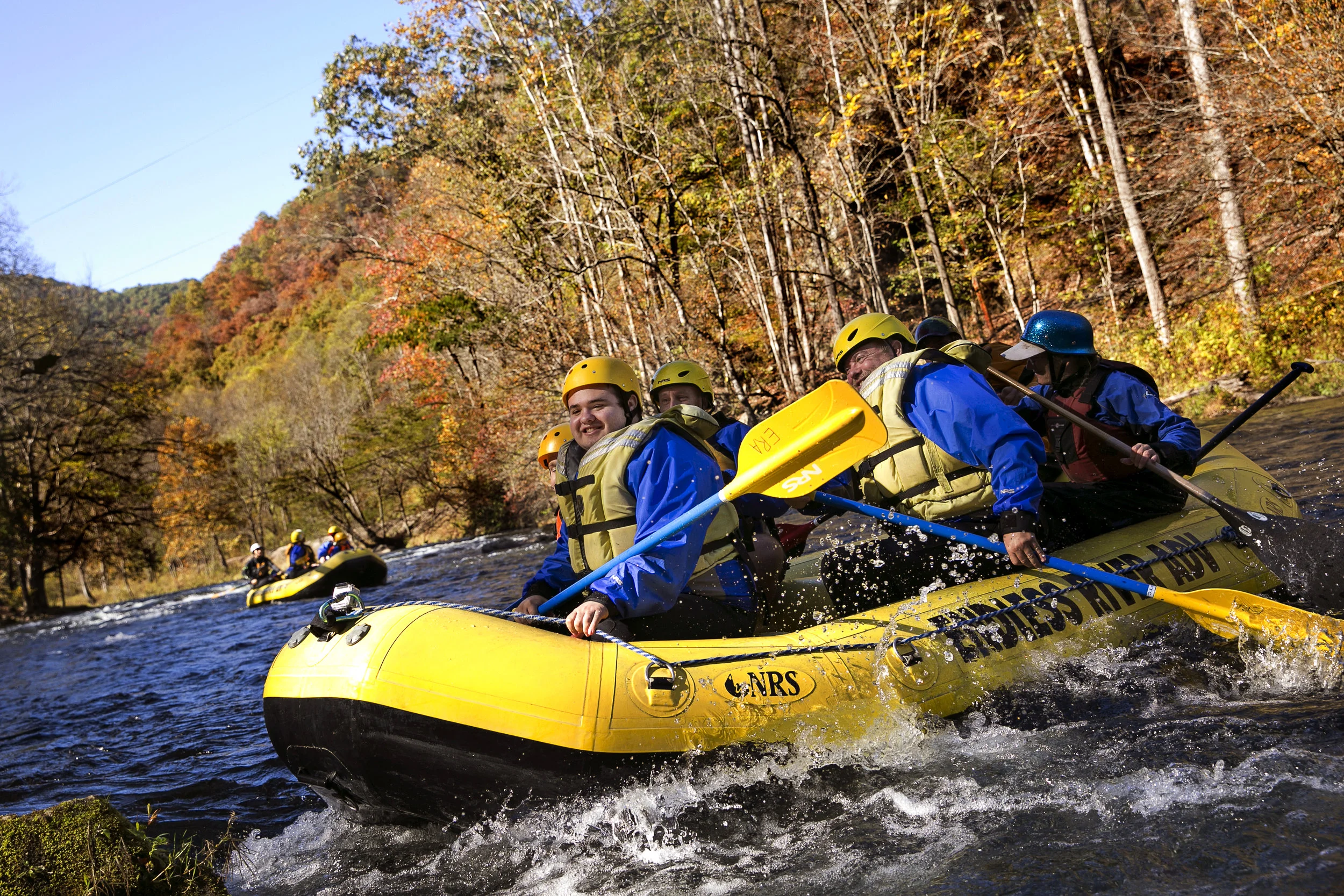 Tucker, center, smiles as the raft hits a rapid while Dennis, right, watches during a Whitewater Healing event on the Nantahala River in Bryson City, N.C. on Oct. 23. Whitewater Healing is a nonprofit that provides whitewater trips for kids with autism and is led by Olympic and world-renowned paddlers. This event was the highlight of the Mashues' year.