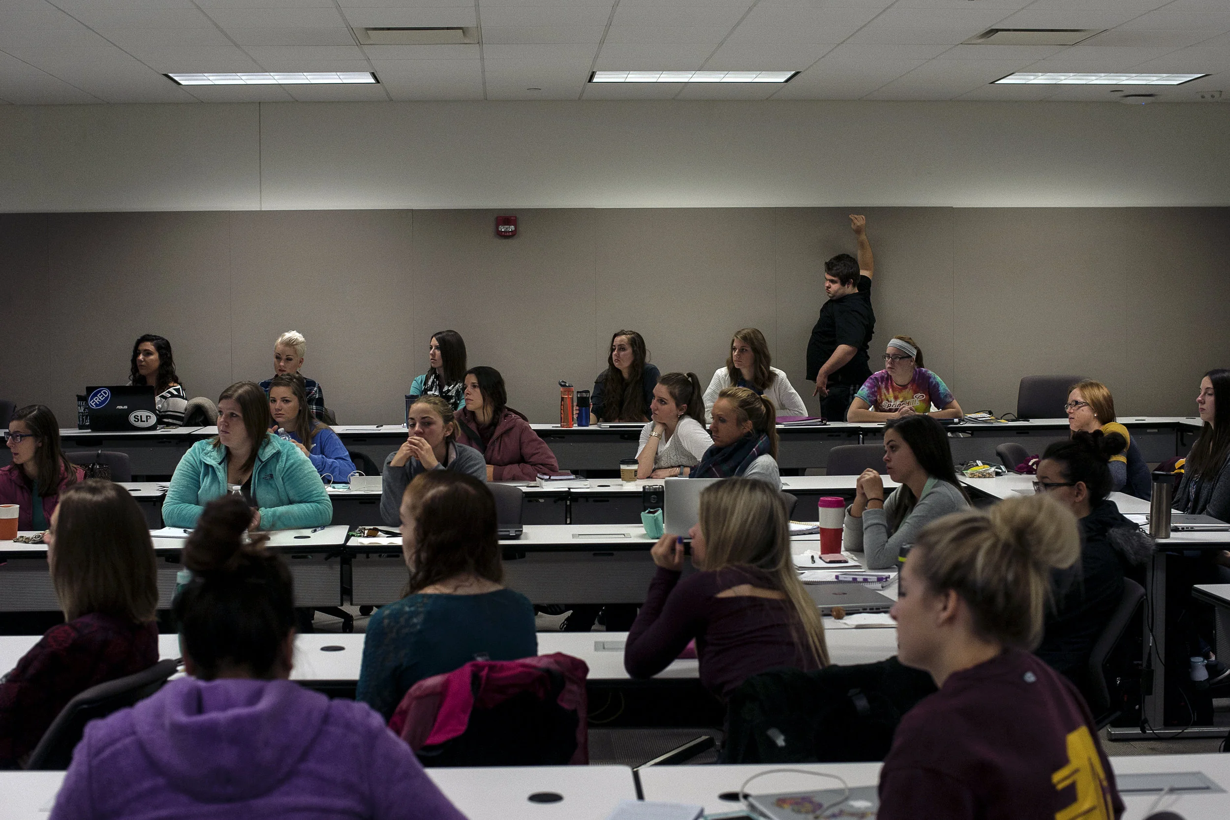 Tucker wanders around the classroom as Dennis completes their presentation to a communications disorders class taught by MaryBeth Smith at Central Michigan University on Nov. 1 in Mt. Pleasant, Mich.