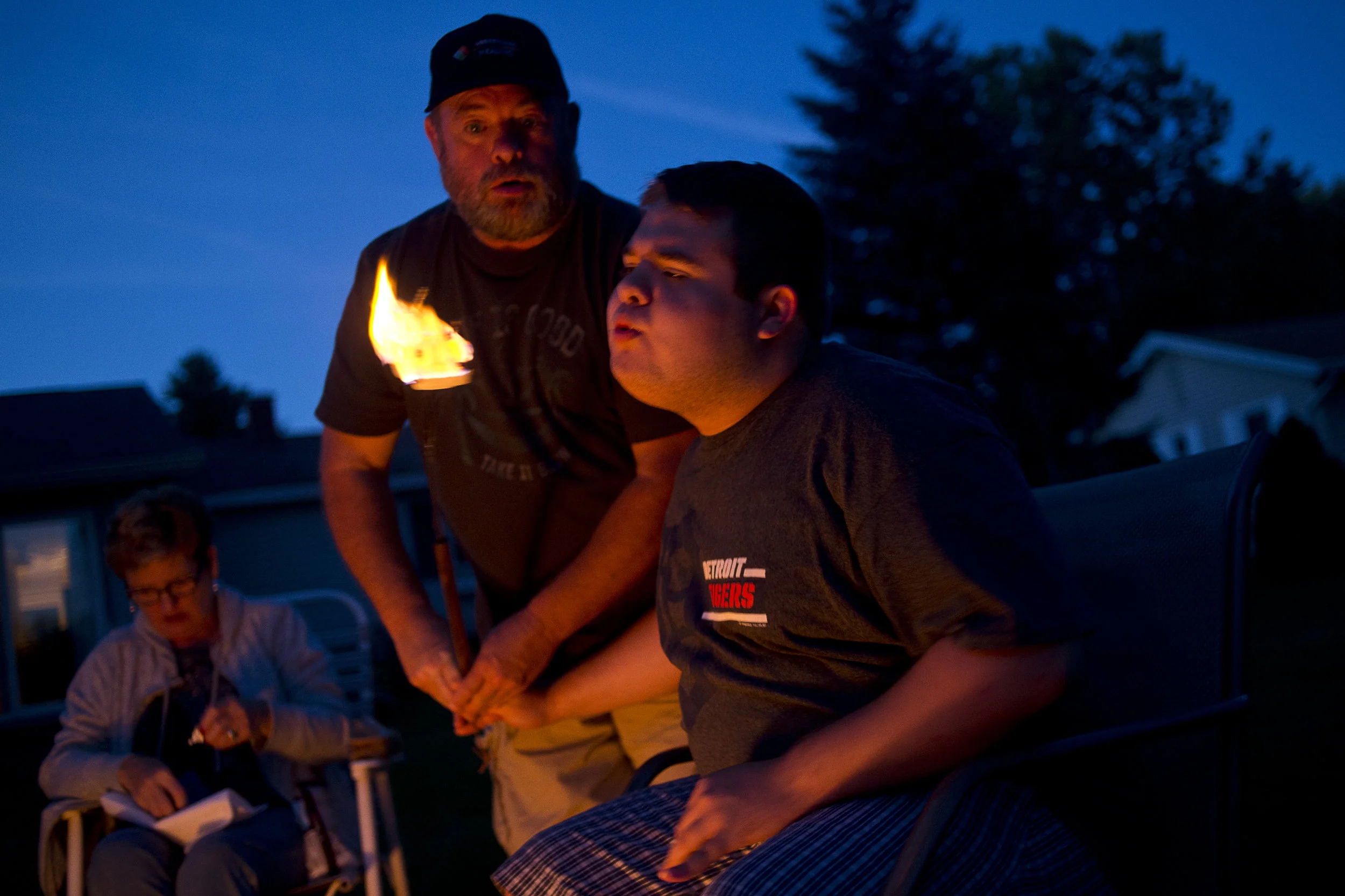 Dennis holds Tucker's hand as he blows out a marshmallow on Sept. 15 in Beaverton, Mich.