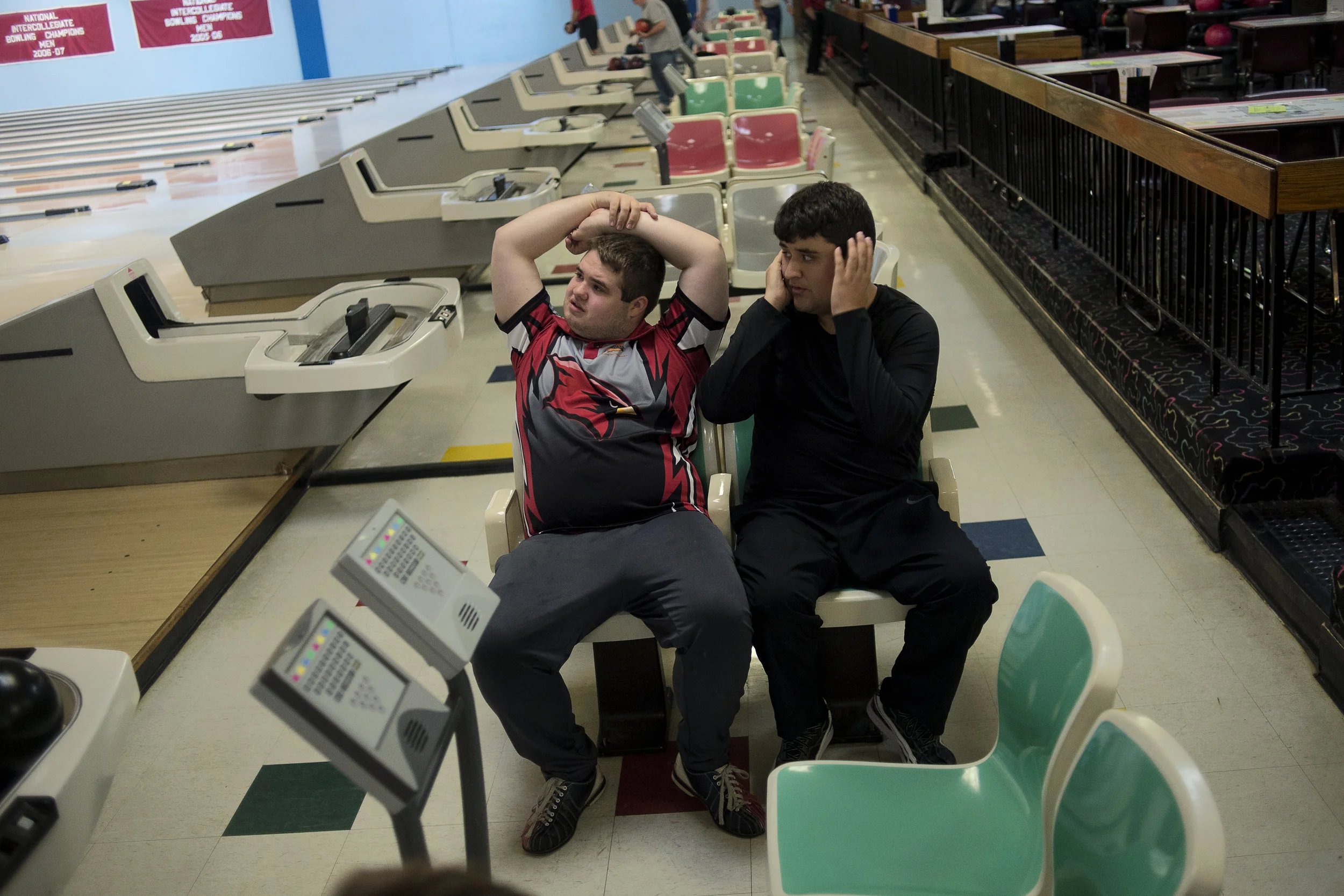 Tucker and his friend Michael Bell, who is also autistic, wait for their turns to bowl during Tucker's 18th birthday party on Nov. 6 at State Lanes in Saginaw, Mich. Both Tucker and Michael bowl with the Saginaw Valley State University Bowling team from time to time.