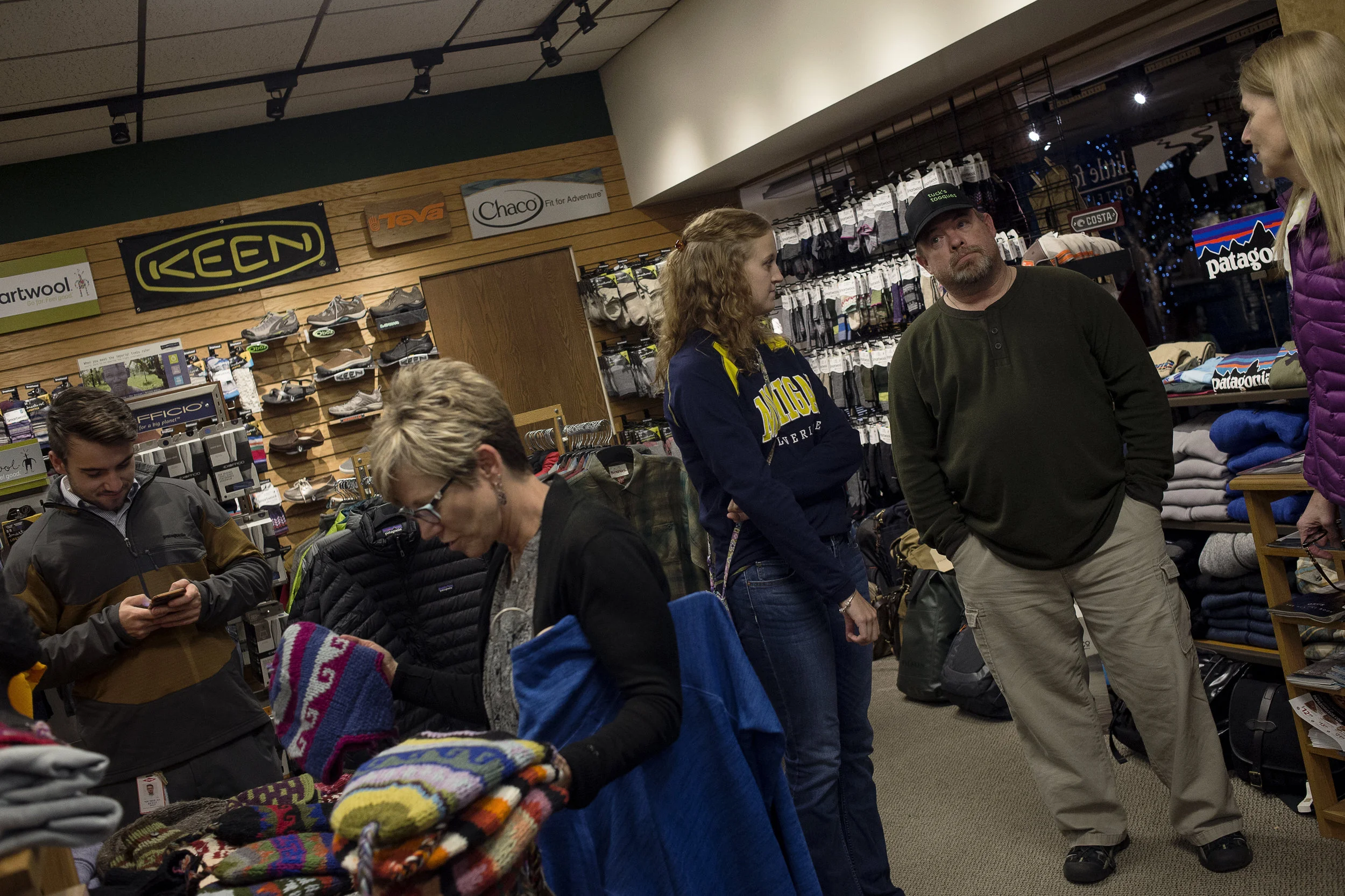Dennis talks with friends and customers at Little Forks Outfitters during a Tuck's Tooques promotion that they held there on Nov. 17 in Midland, Mich.